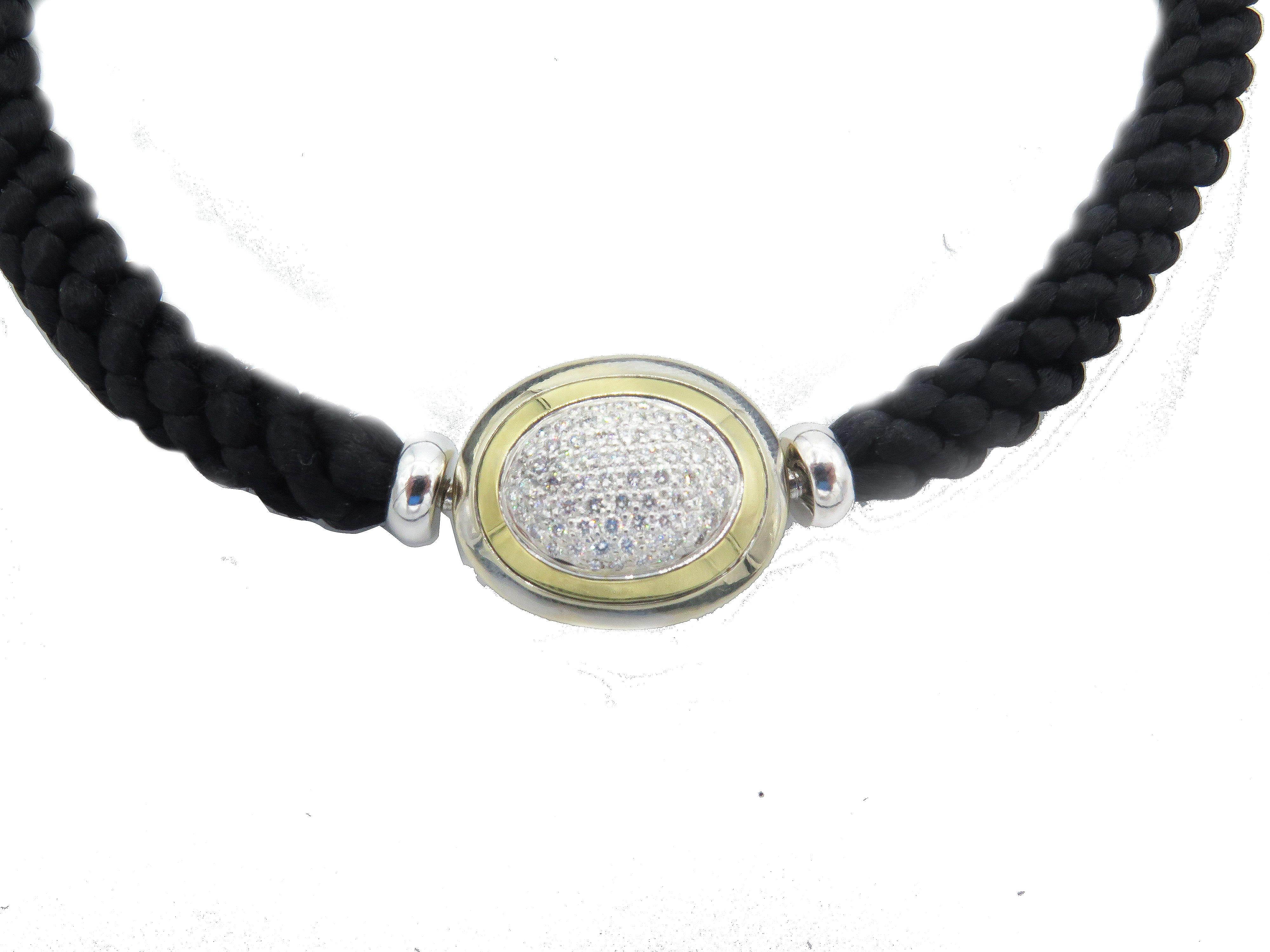  Crafted with the highest quality materials, this Hammerman Fine Diamond Choker is an elegant piece of neck jewelry. This luxurious cord necklace measures 15.75 inches in length and the width/thickness is 0.25 inches. The 18k gold oval is 0.75in