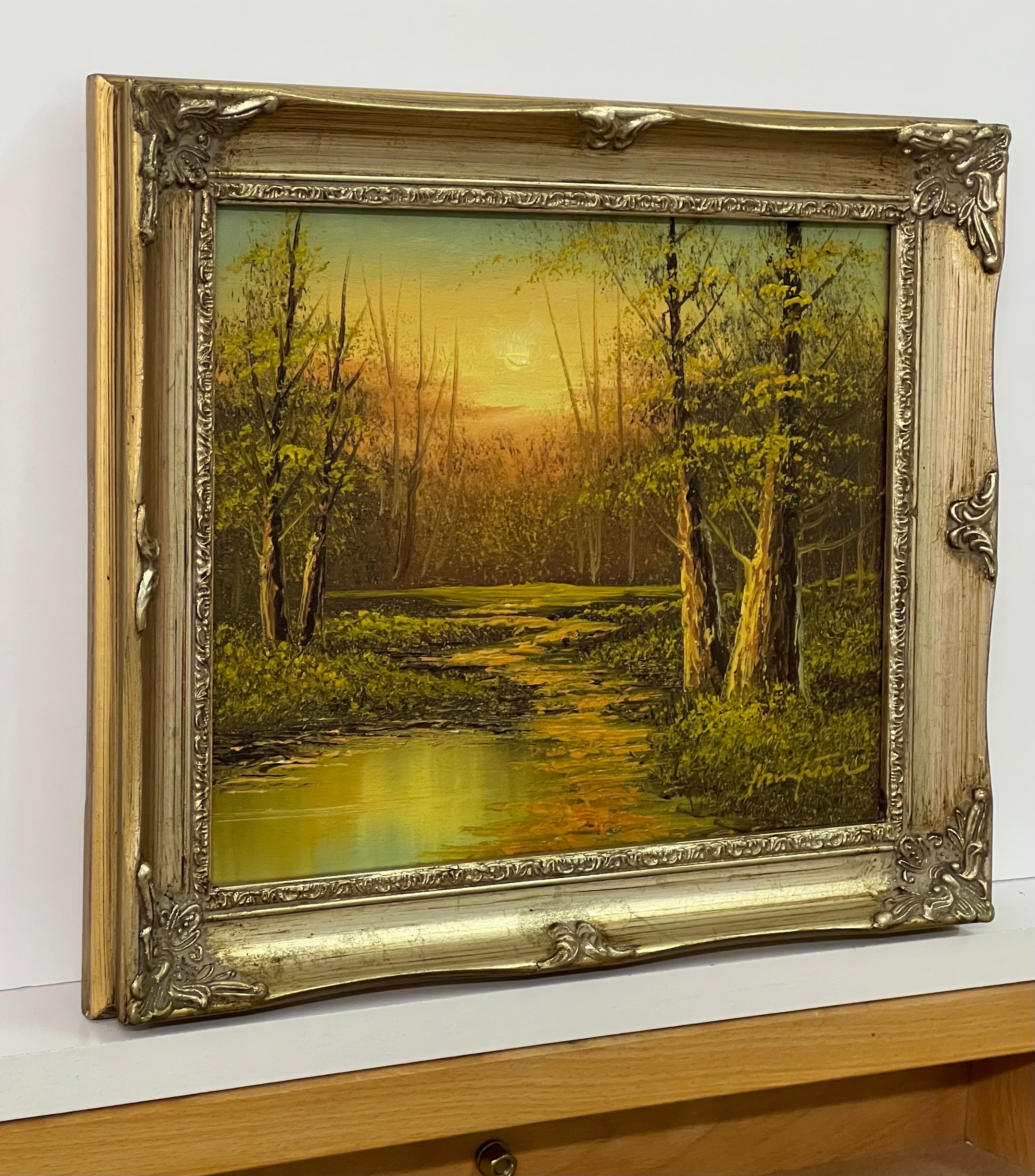 Vintage Oil Painting of River Sunset in the Woods of the English Countryside by 20th Century British Artist. Painted using warm orange and green colours creating a unique atmosphere. 

Art measures 10 x 8 inches 
Frame measures 12 x 10 inches