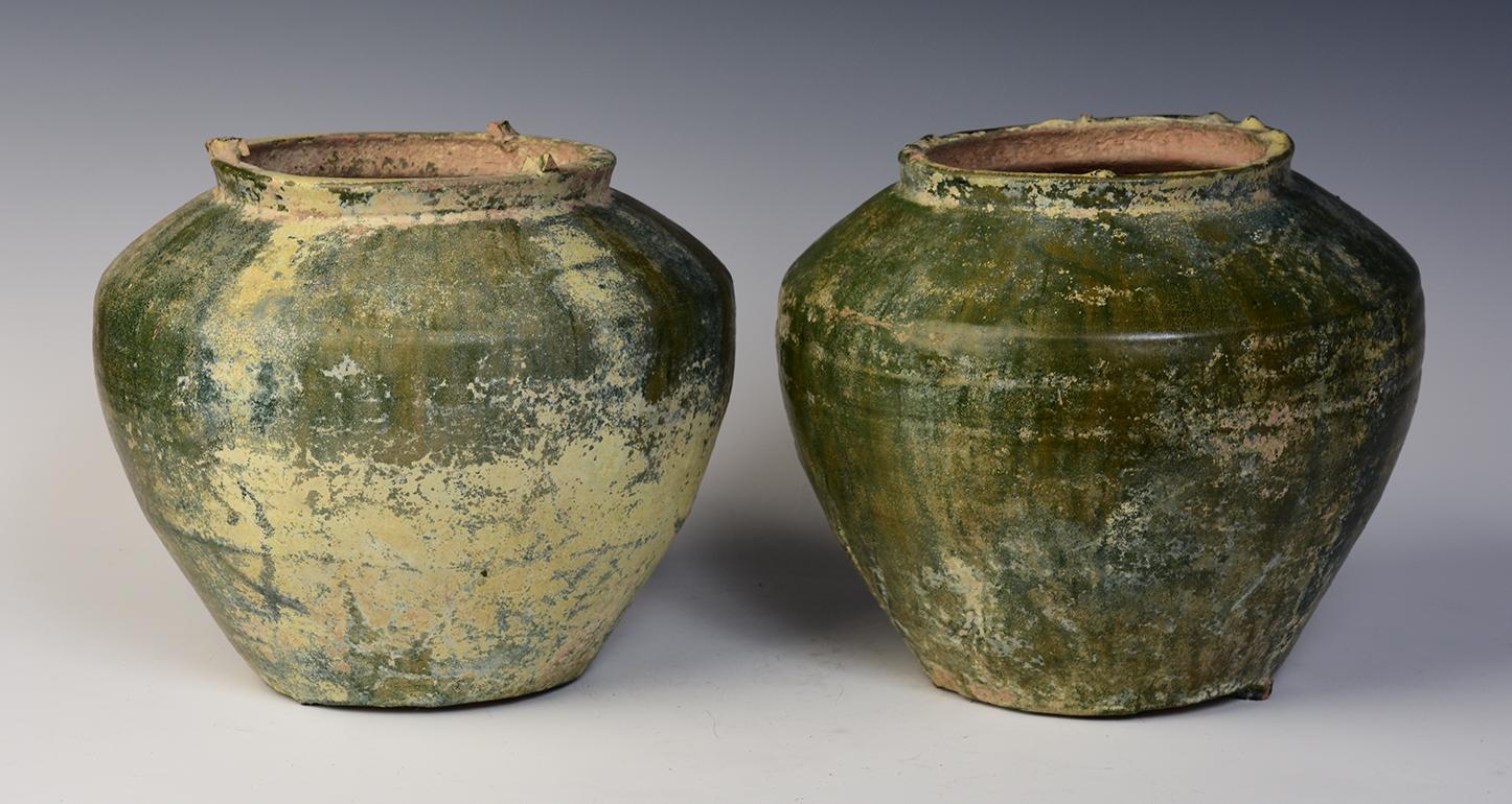 A pair of Chinese green glazed pottery jars. 
Lead glaze with copper is the main colorant used in Han period to produce green glaze. Greenware became popular during the Eastern Han period.

Age: China, Han Dynasty, 206 B.C. - A.D. 220
Size: