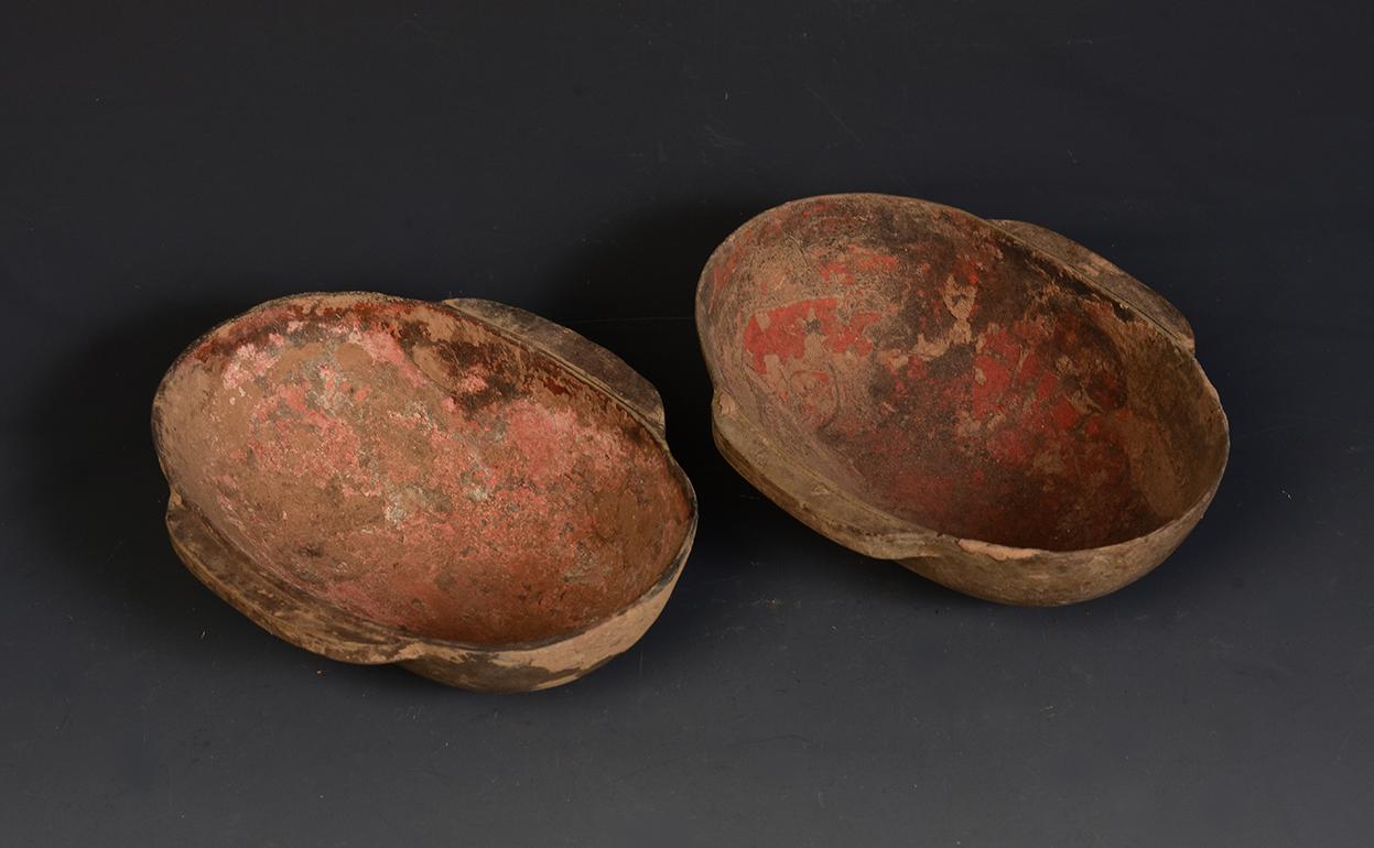 A pair of antique Chinese painted pottery wine cup with traces of original red pigment. Wine cup in this elliptical shape with two ears is also known as 
