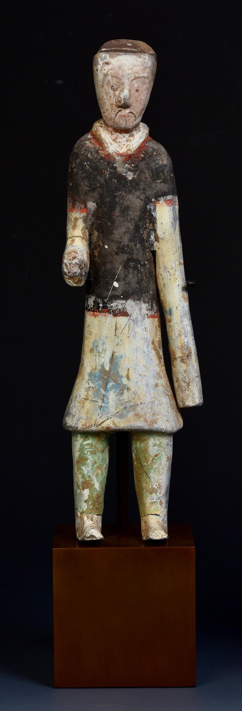 A pair of Chinese painted pottery groom figures.

Age: China, Han Dynasty, 206 B.C. - A.D. 220
Size: Height 24.8 C.M. / Width 7.7 C.M. / Height including stand 32 C.M.
Condition: Well-preserved old burial condition overall with some amount of soil