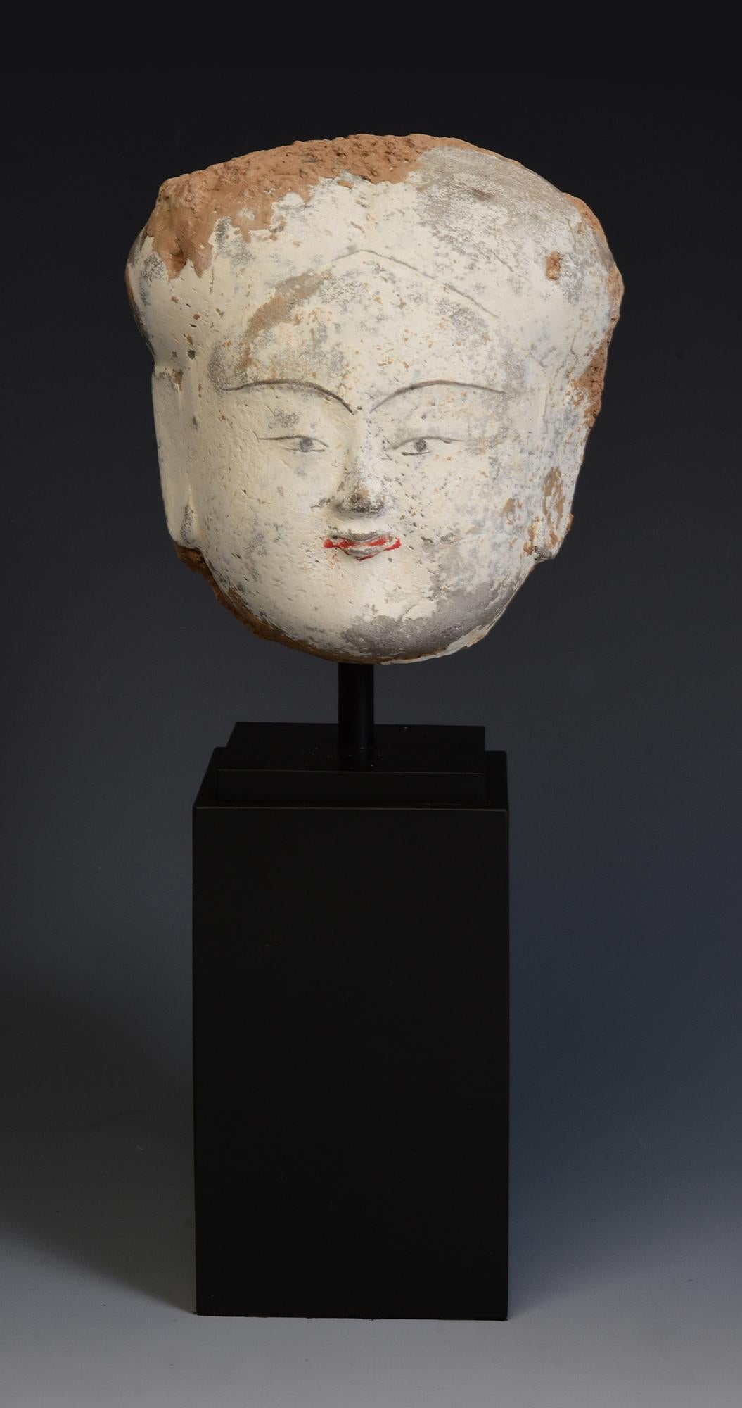 Antique Chinese pottery head of court lady.

Age: China, Han Dynasty, 206 B.C. - A.D. 220
Size of head only: Height 11.5 C.M. / Width 11.2 C.M. / Depth 8.8 C.M.
Height including stand: 26 C.M.
Condition: Well-preserved old burial condition overall