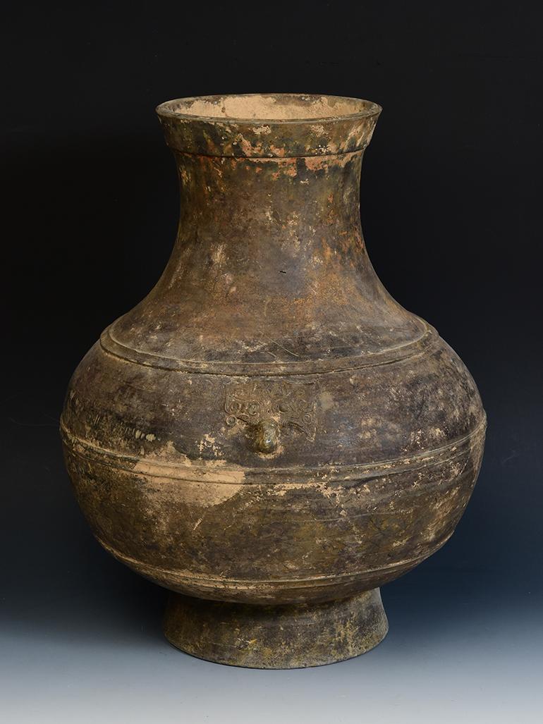 Chinese pottery Hu jar decorated with bands of raised lines and a pair of monster masks on the shoulder.

Age: China, Han Dynasty, 206 B.C. - A.D.220
Size: height 45 cm / width 37 cm.
Condition: Well-preserved old burial condition overall with