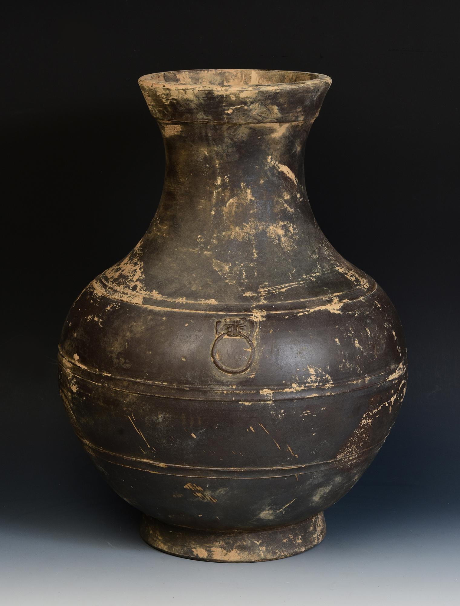 Antique Chinese pottery Hu jar decorated with bands of raised lines and a pair of monster masks on the shoulder.

Age: China, Han Dynasty, 206 B.C. - A.D.220
Size: Height 46.6 C.M. / Width 34 C.M.
Condition: Well-preserved old burial condition