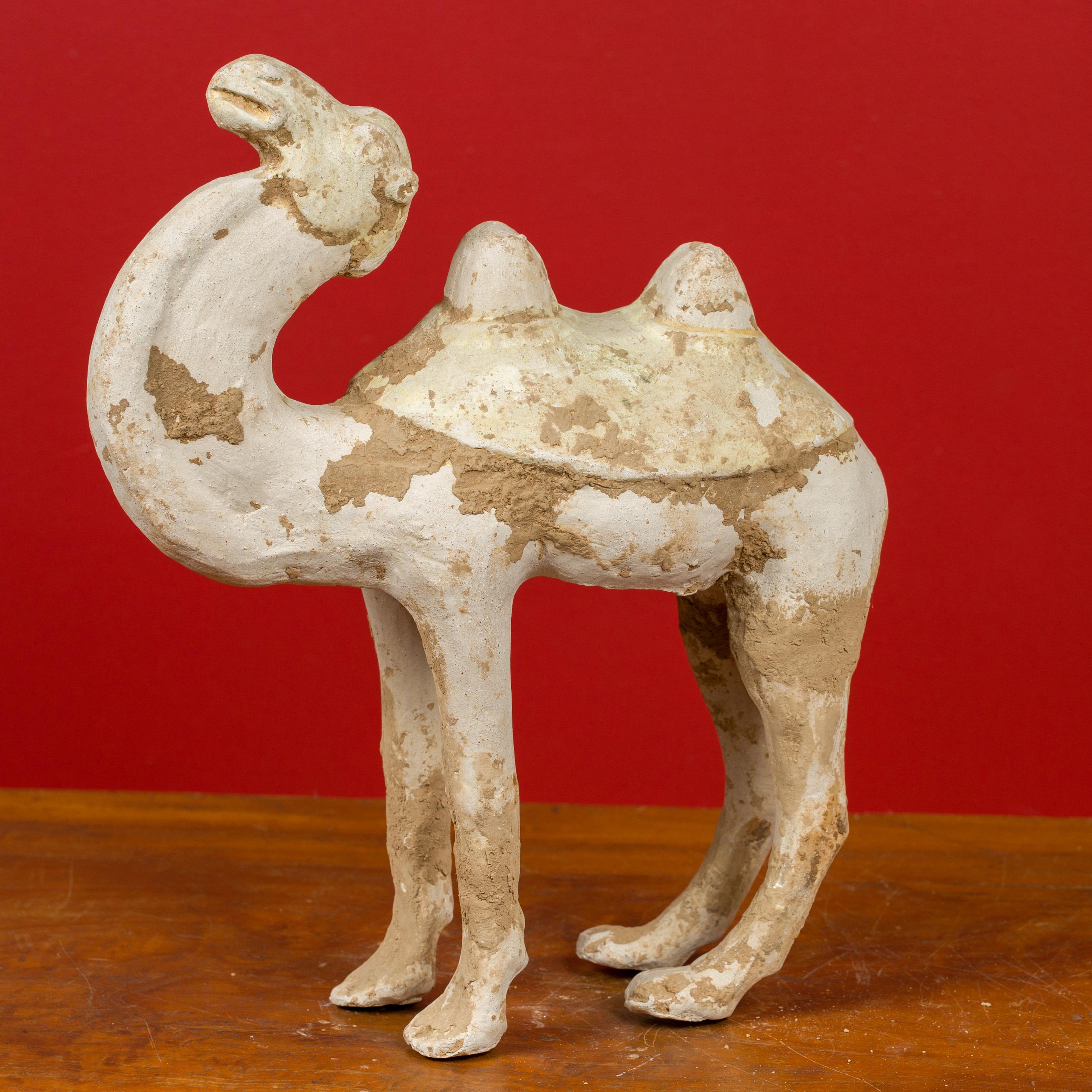 A Chinese Han Dynasty period mingqi terracotta camel circa 202 BC-200 AD, with mineral deposits. Created in China during the Han Dynasty, this mingqi, a funerary statue created to be buried with the deceased to secure an enjoyable afterlife,
