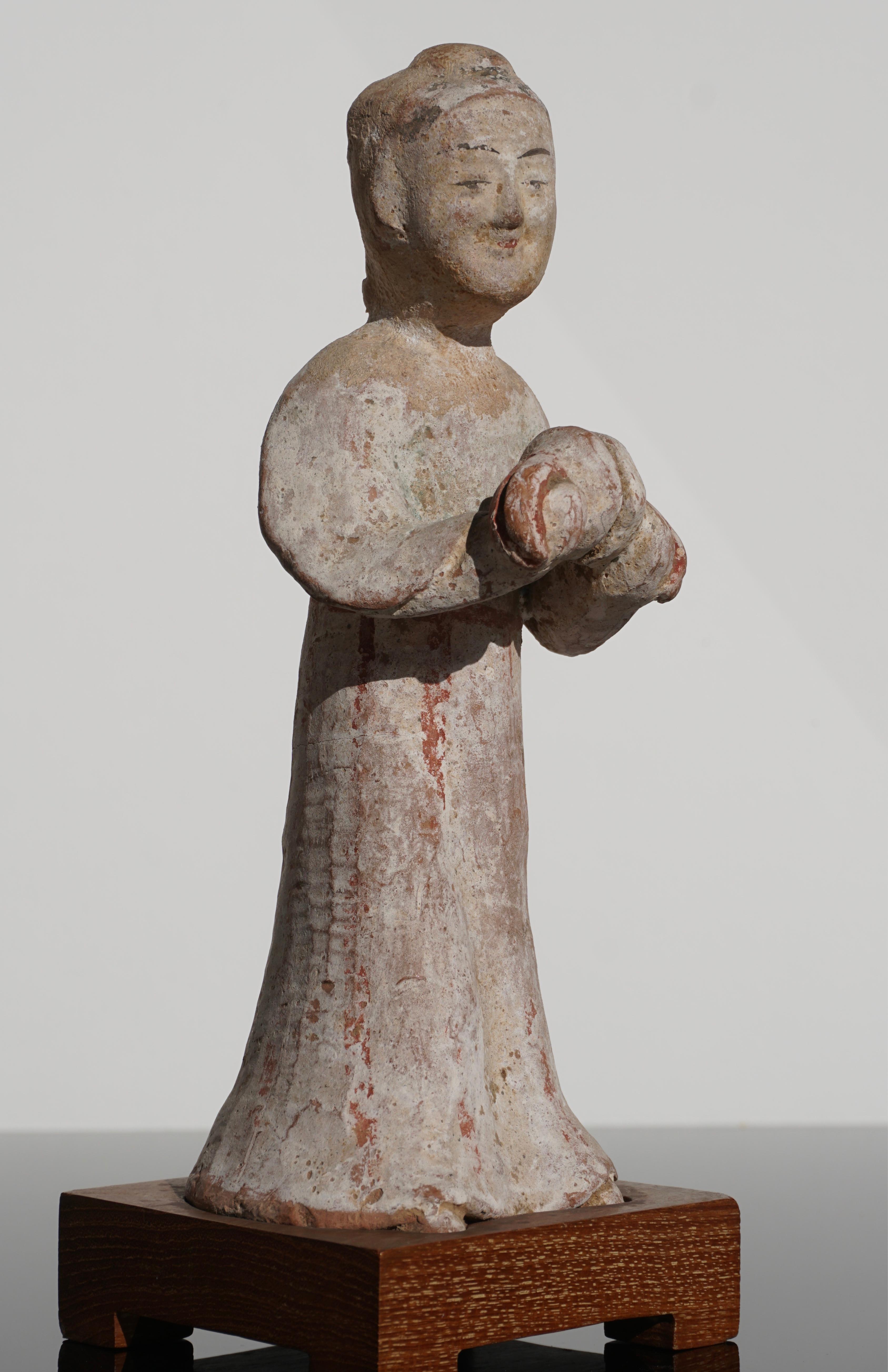 East Asia, China, Han dynasty, circa 200 BCE.

A female polychrome painted terracotta pottery tomb figure of a type known as a mingqi, or 