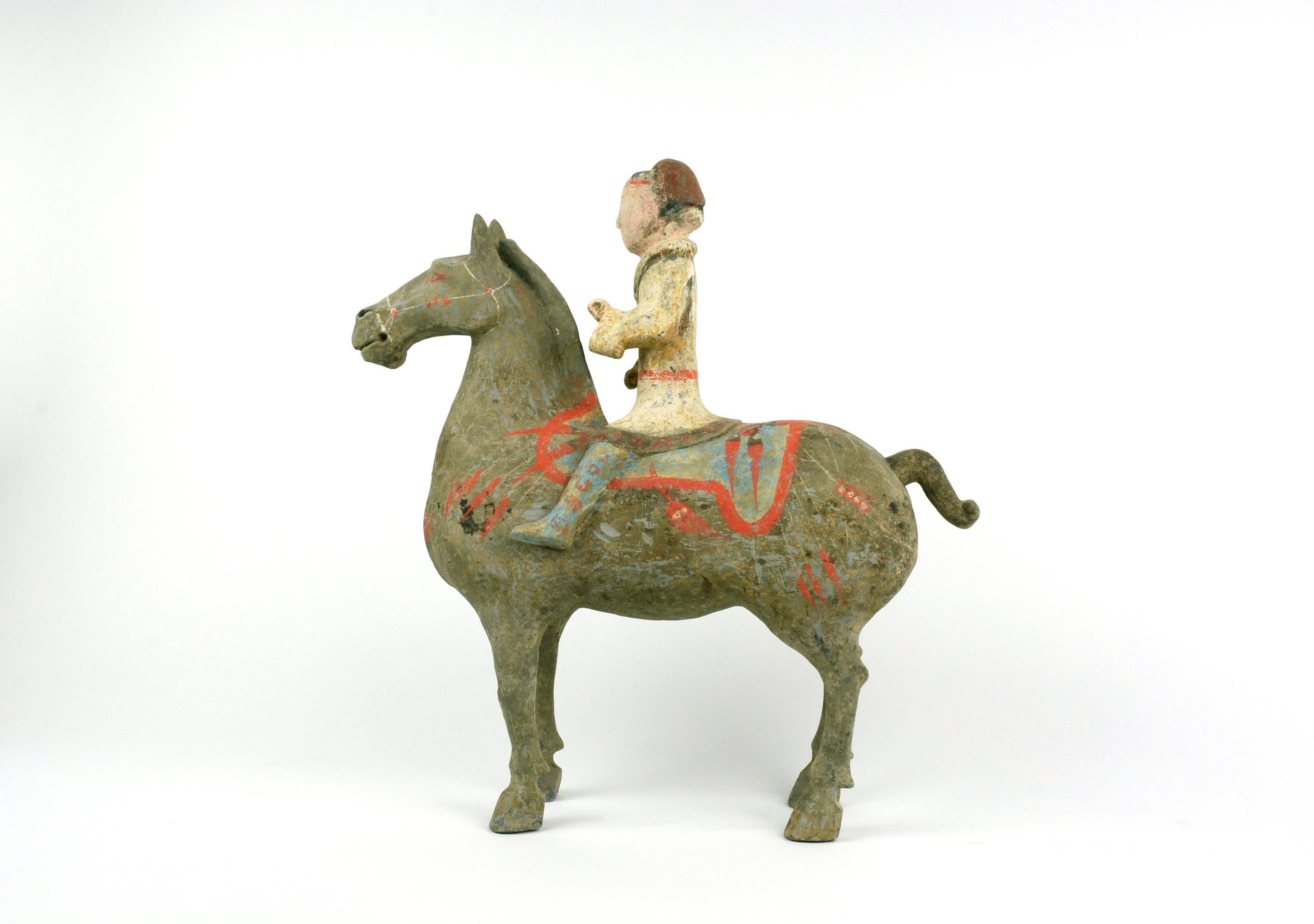 Han Equestrian 12H.
This equestrian represents the standard of Western Han equestrian found in Yang Jiawan of Xian. The technique of making includes molding, engraving and cold painting. The terracotta piece was first molded and the details were