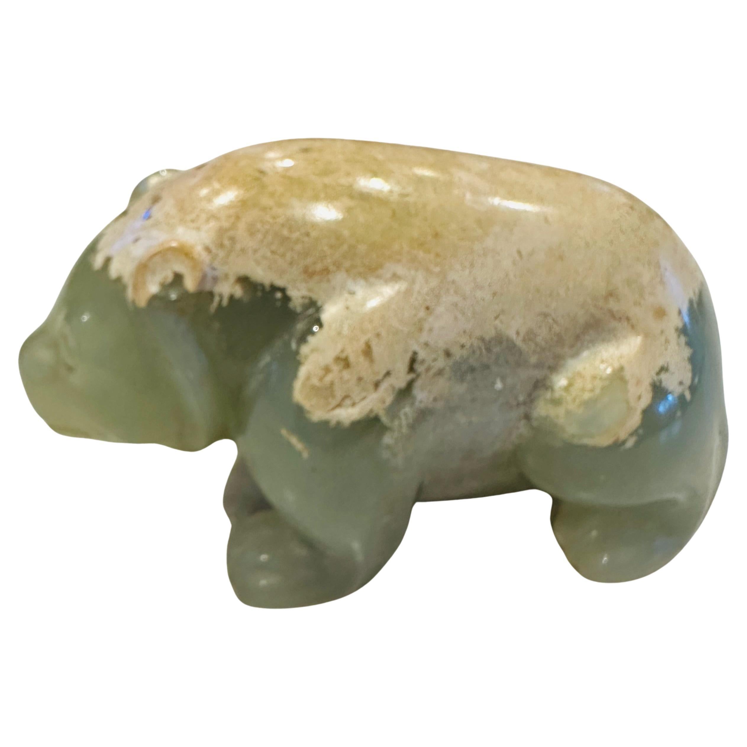 Han Dynasty (206 B.C.E to 226 A.D.) green jade bear. The bear is standing stoutly on his four paws, his round eyes gazing forward above a blunt snout, his plump body extending to a short tail, the well-padded haunches extending to the muscular legs