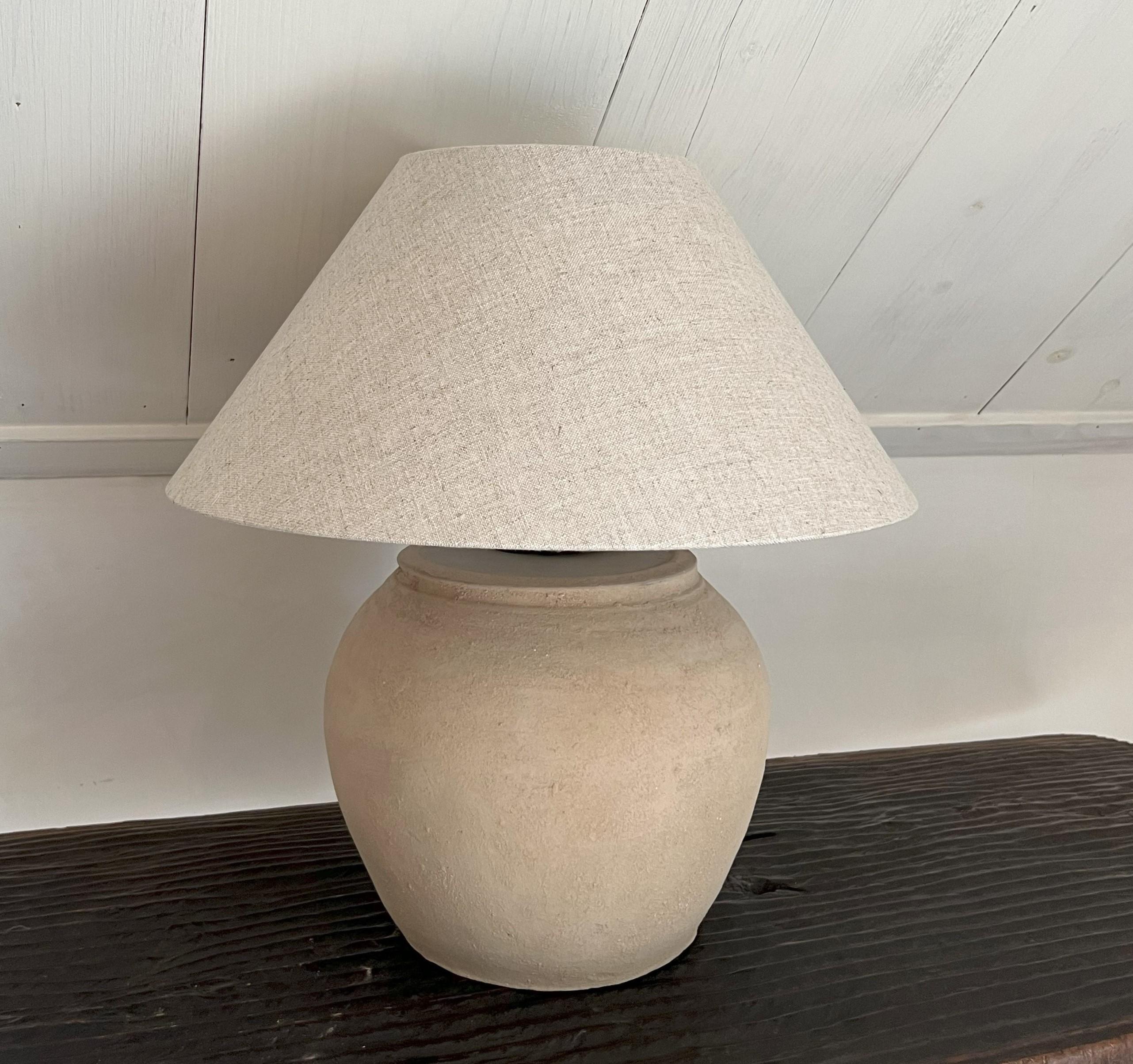 A Chinese Han style vase turned in to a tablelamp. Made from unglazed grey earthenware in a pot shape with subtle sandgrain patina. This vase has a great untouched patina with no cracks or restaurations. 
