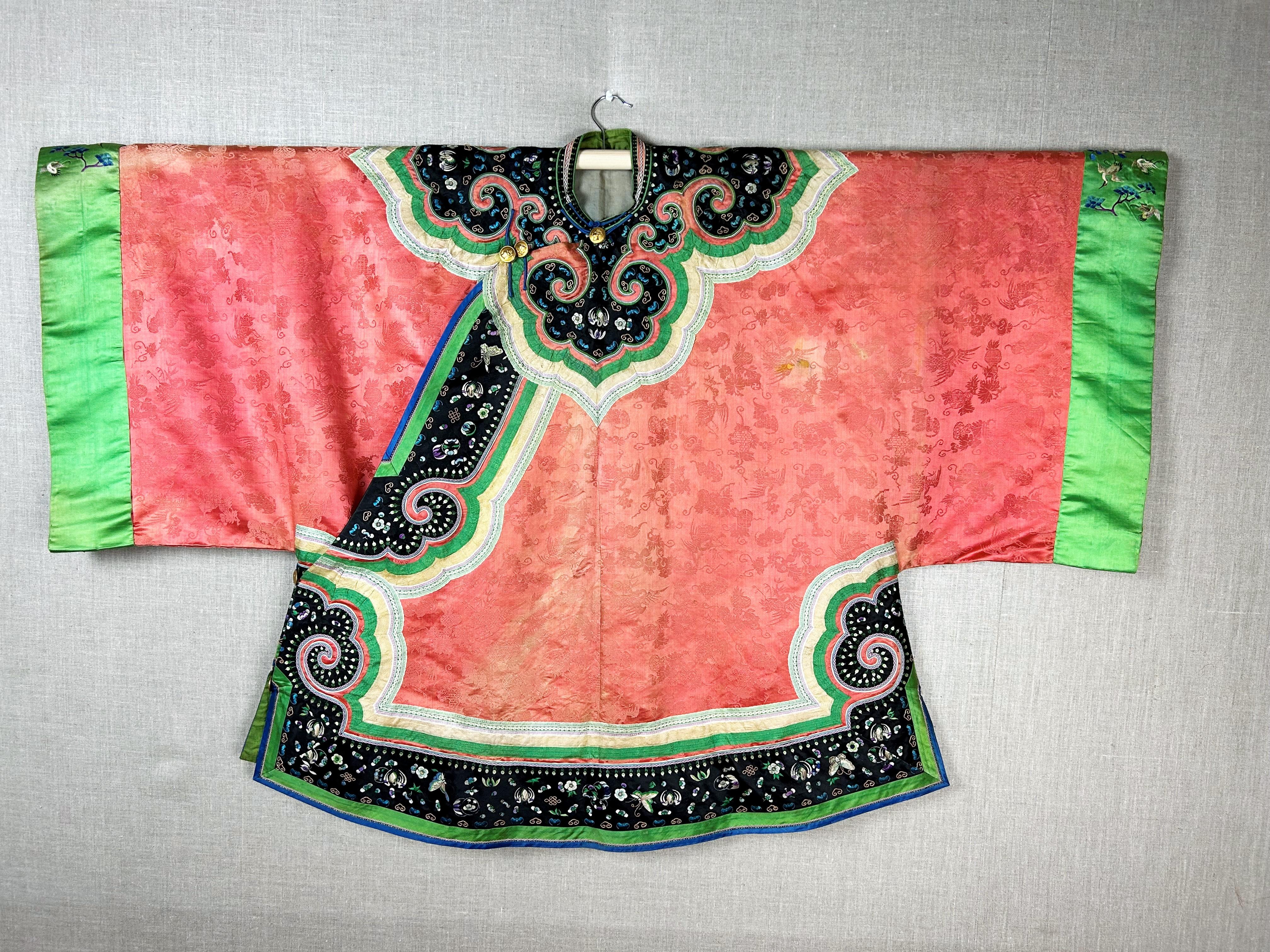 Late 19th century

China Qing period

Beautiful Han woman's embroidered silk ceremonial tunic dating from the late 19th century. Tangerine orange damask taffeta background representing the auspicious signs of Buddhism. Long tunic crossed by six