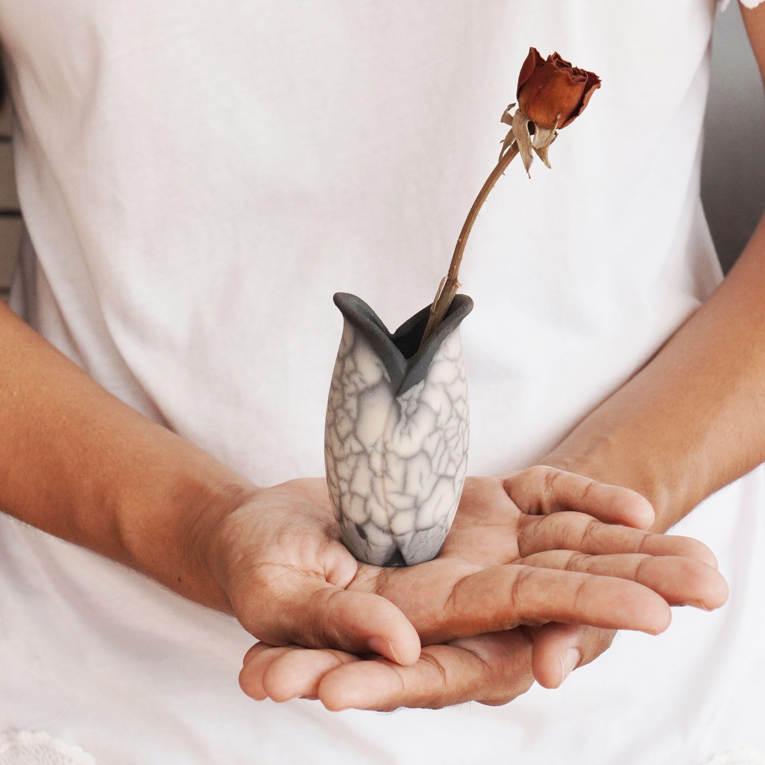 Hana F ~ 花 Flower. 

Our Hana F mini raku vase is clay representation of a tulip flower. Two overlapping petals form the body of this mini vase. This vase makes for an adorable gift or a tabletop decorative piece that truly stands out. Each piece is