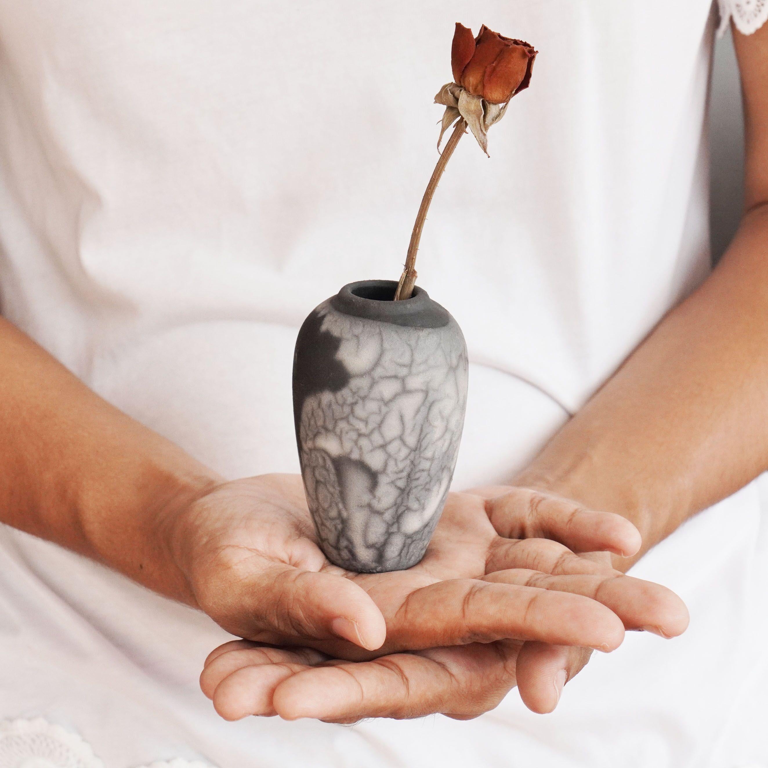 Hana L ~ 花 flower 

Our Hana L mini raku vase represents a miniature urn with a bulbous top tapers slenderly to a smaller base. This vase makes for an adorable gift or a tabletop decorative piece that truly stands out. Each piece is individually