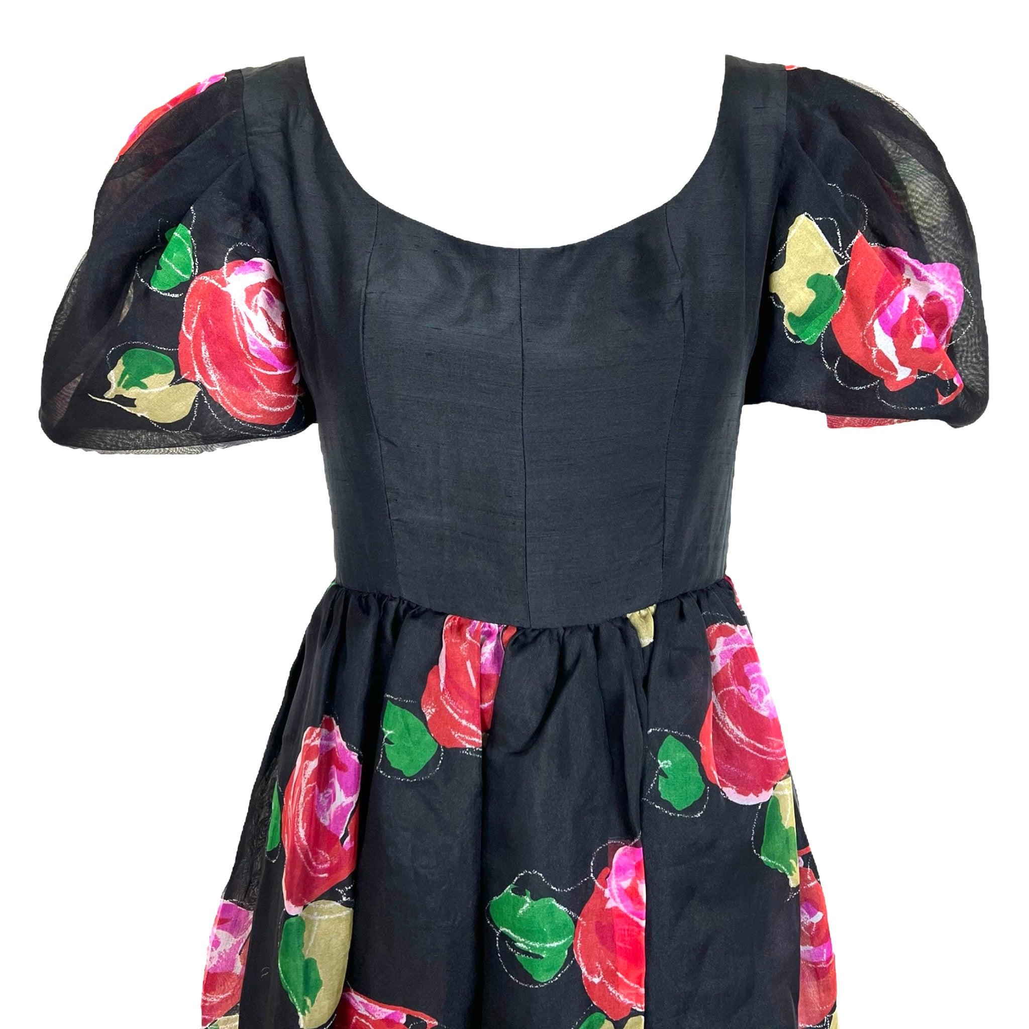 Vibrant and romantic floral printed silk dress by Hanae Mori. A 1980's dress with a nod to the femininity of the 1950's. Slightly high-waisted but not quite an empire-waisted silhouette, this dress has a scoop neck and puff sleeves. Painterly red
