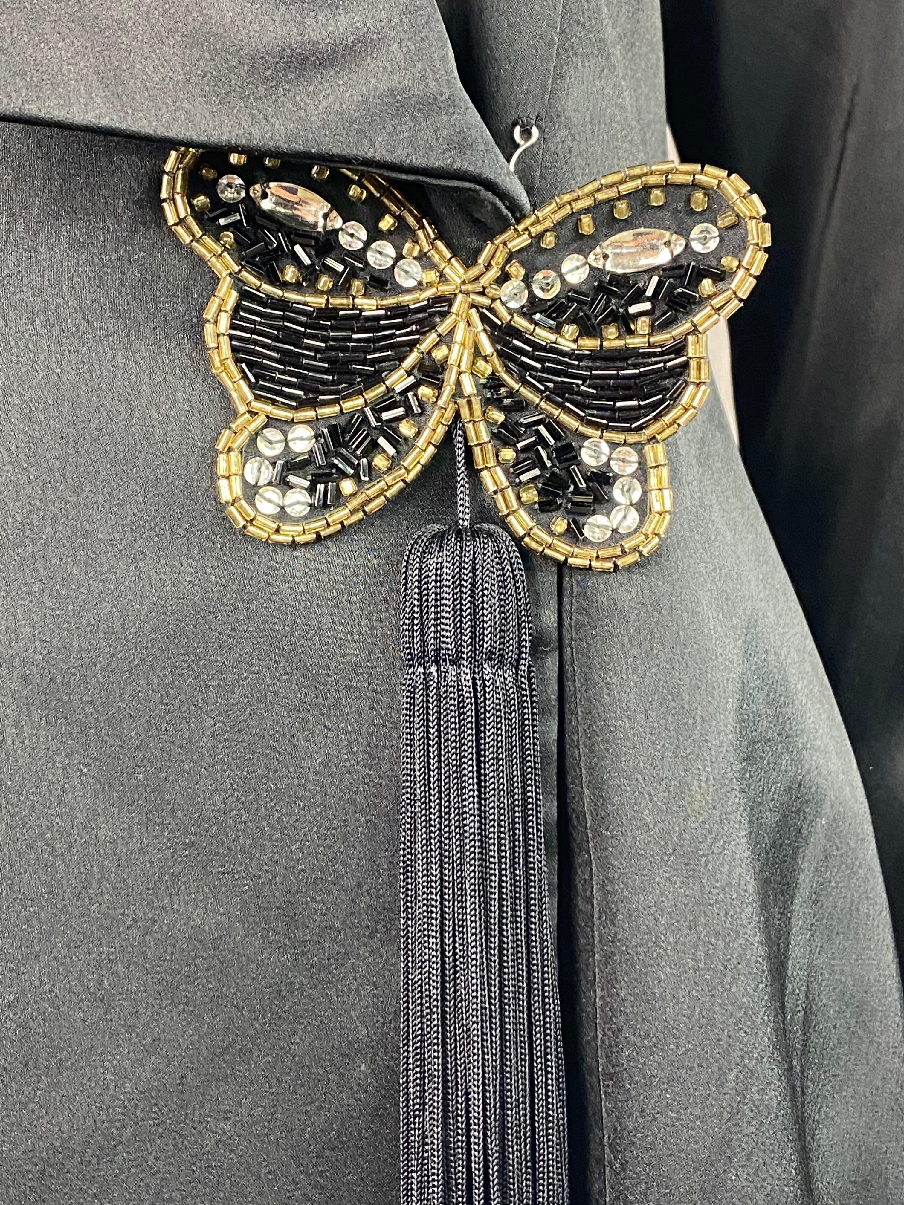 Product details:

The jacket features front hook closure with rhinestones butterfly detail and black tussle. Tags are missing. 