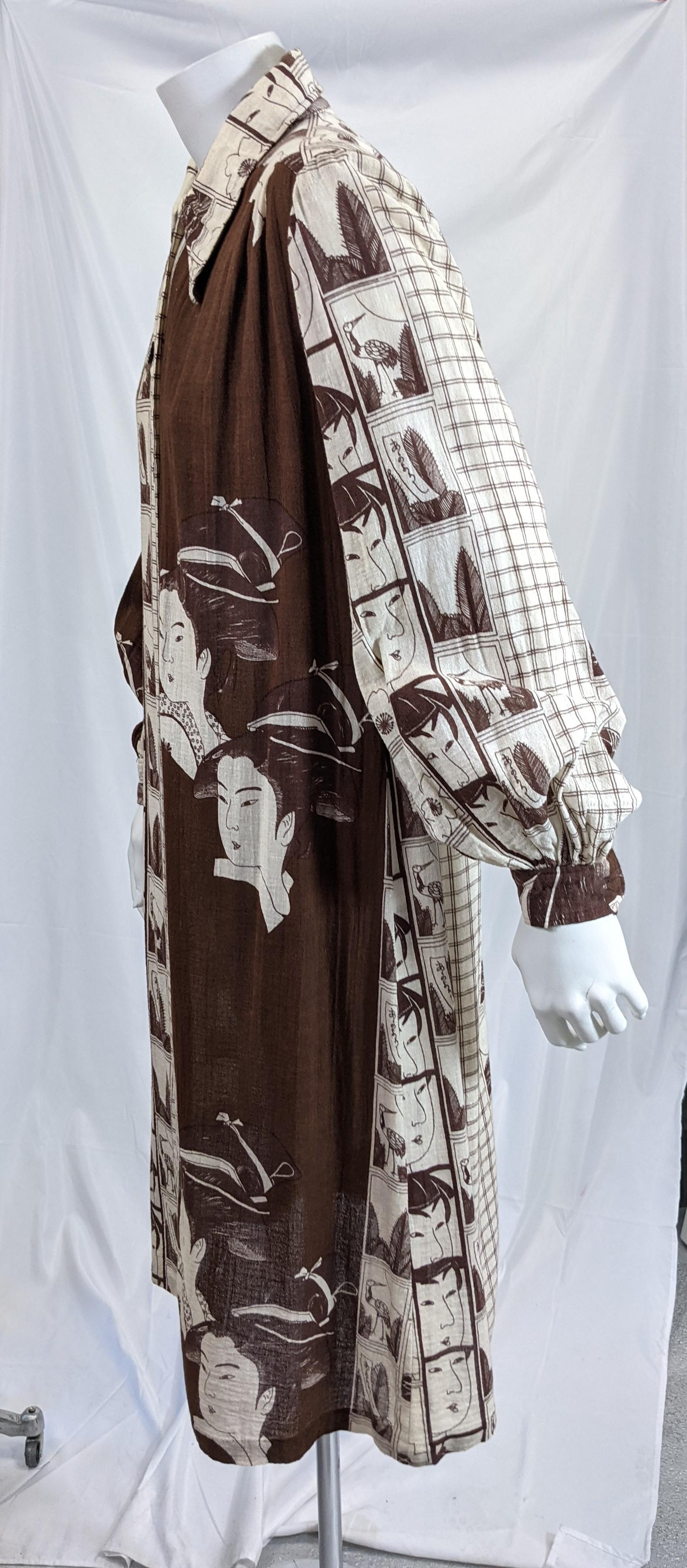 Hanae Mori long sleeved crinkle cotton gauze print dress. Printed with double geisha faces and film strip like blocks of japanesque images on a deep brown and white background. Simple loose fitting shirtdress, styling works well with self