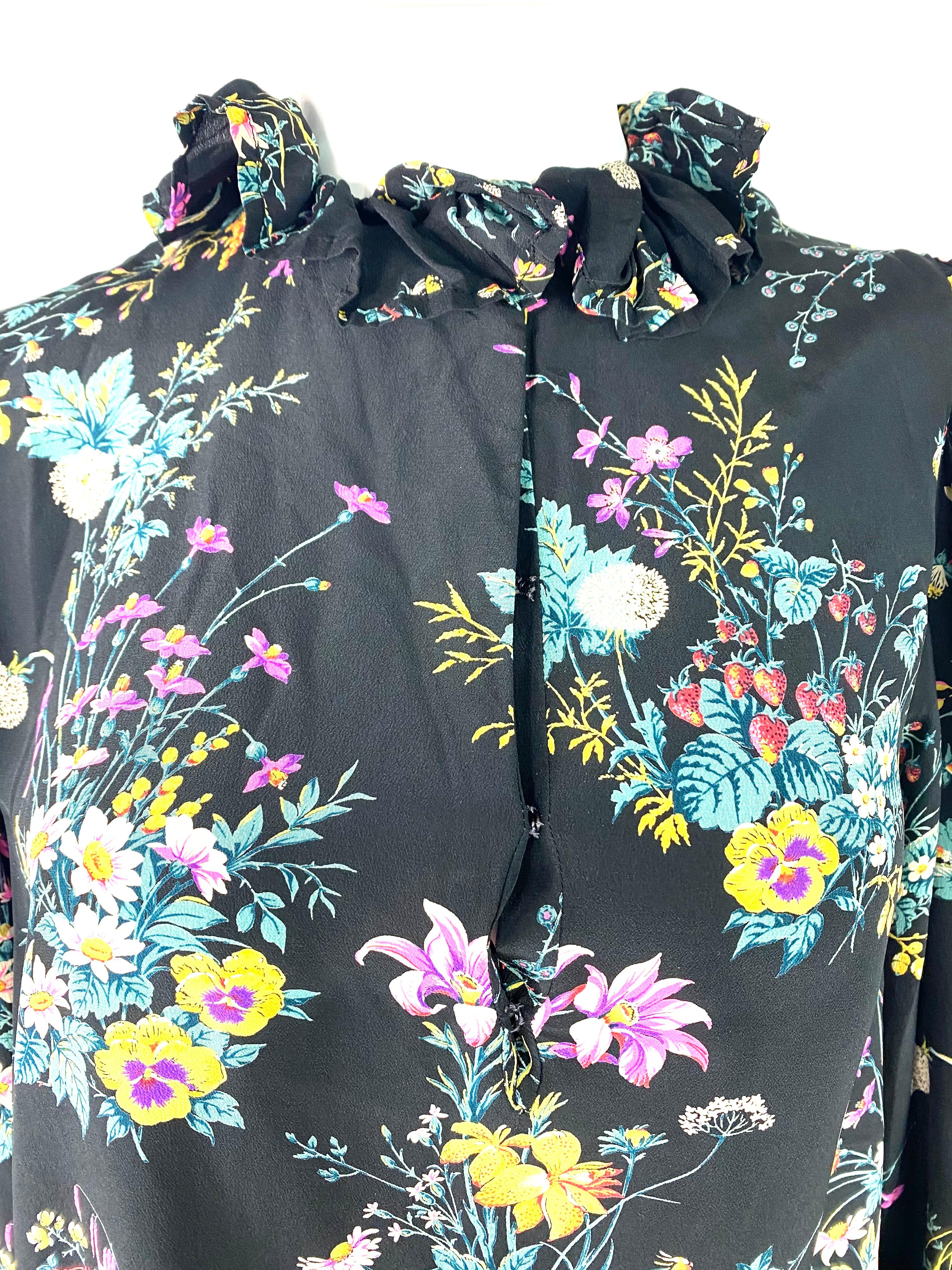 Product details:

The dress features floral and fruity print on the black background, mini length, side pockets, long sleeves, ruffled collar detail. Made in France.