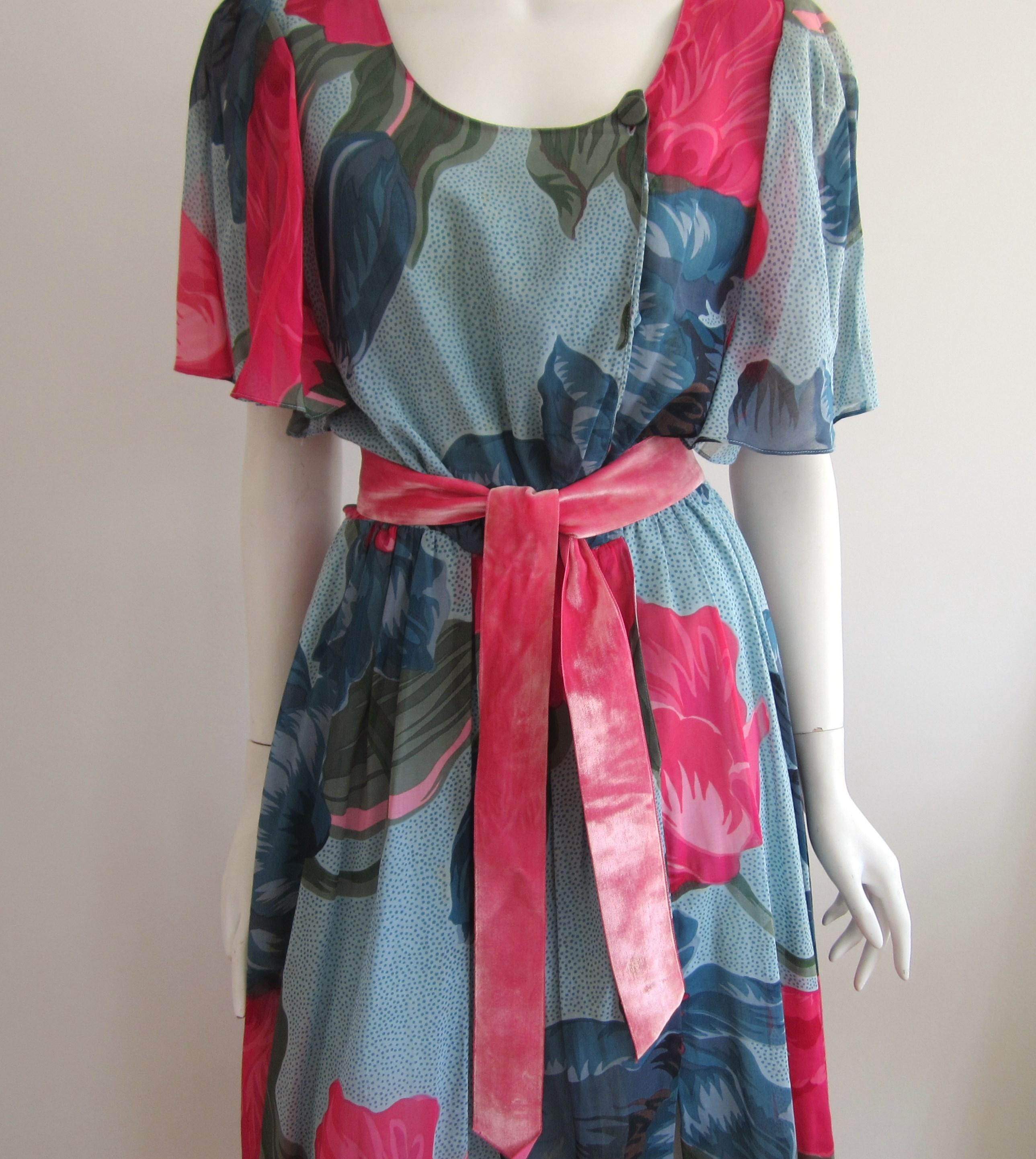 Vintage 1980s Hanae Mori Dress. Lovely flowing sleeves. Velvet belt. Clip, snaps and button closure with Pockets! Labeled a size 10- Measuring Up to 38 chest -- Up to 26 Waist -- Up to 40 Hips -- Length down the back 47in.  Please be sure to check