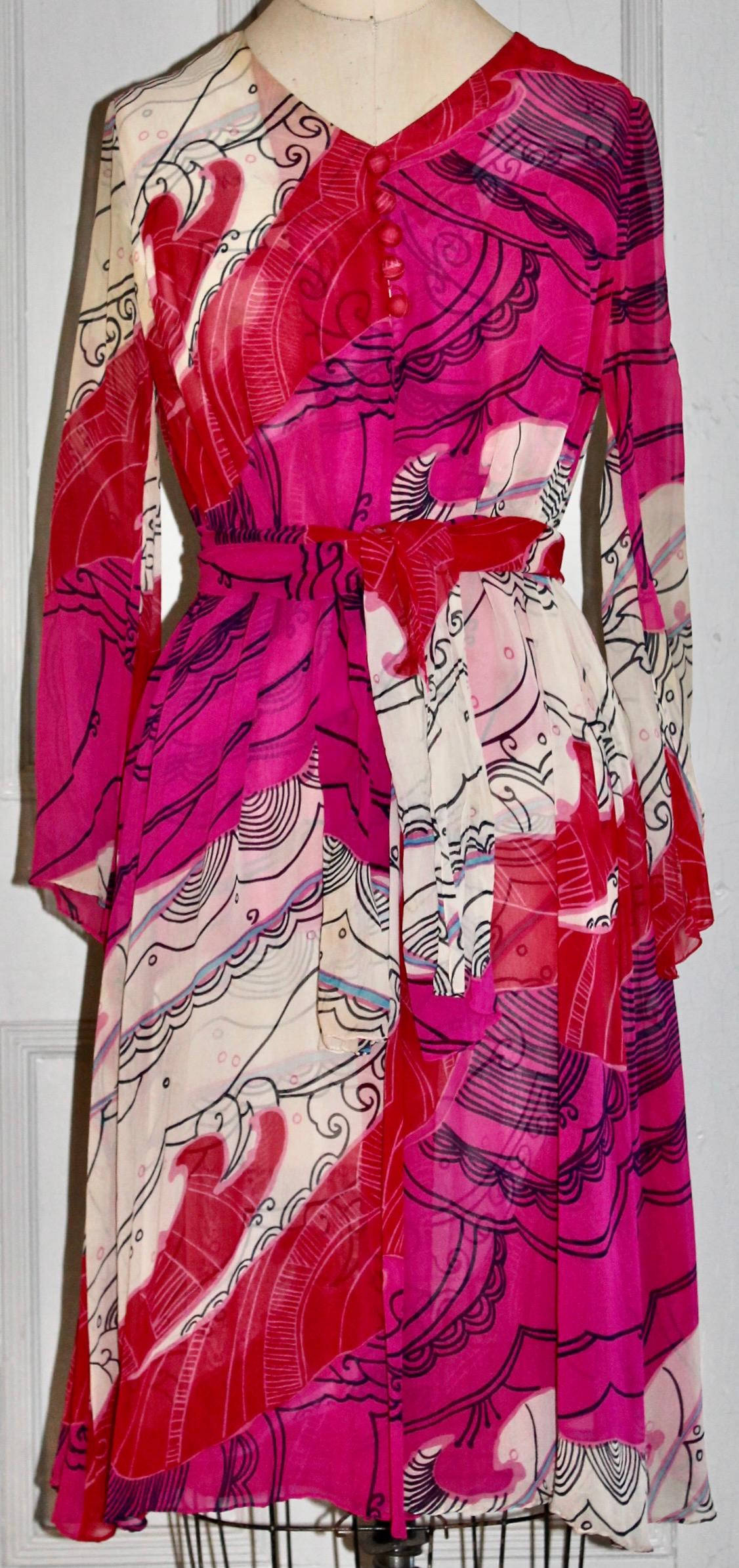 A beautiful 100% silk evening dress, with attached silk 'coat' by the important Japanese Fashion Designer.  Abstracted floral/sea pattern in white black pinks and blue.  Sash (56