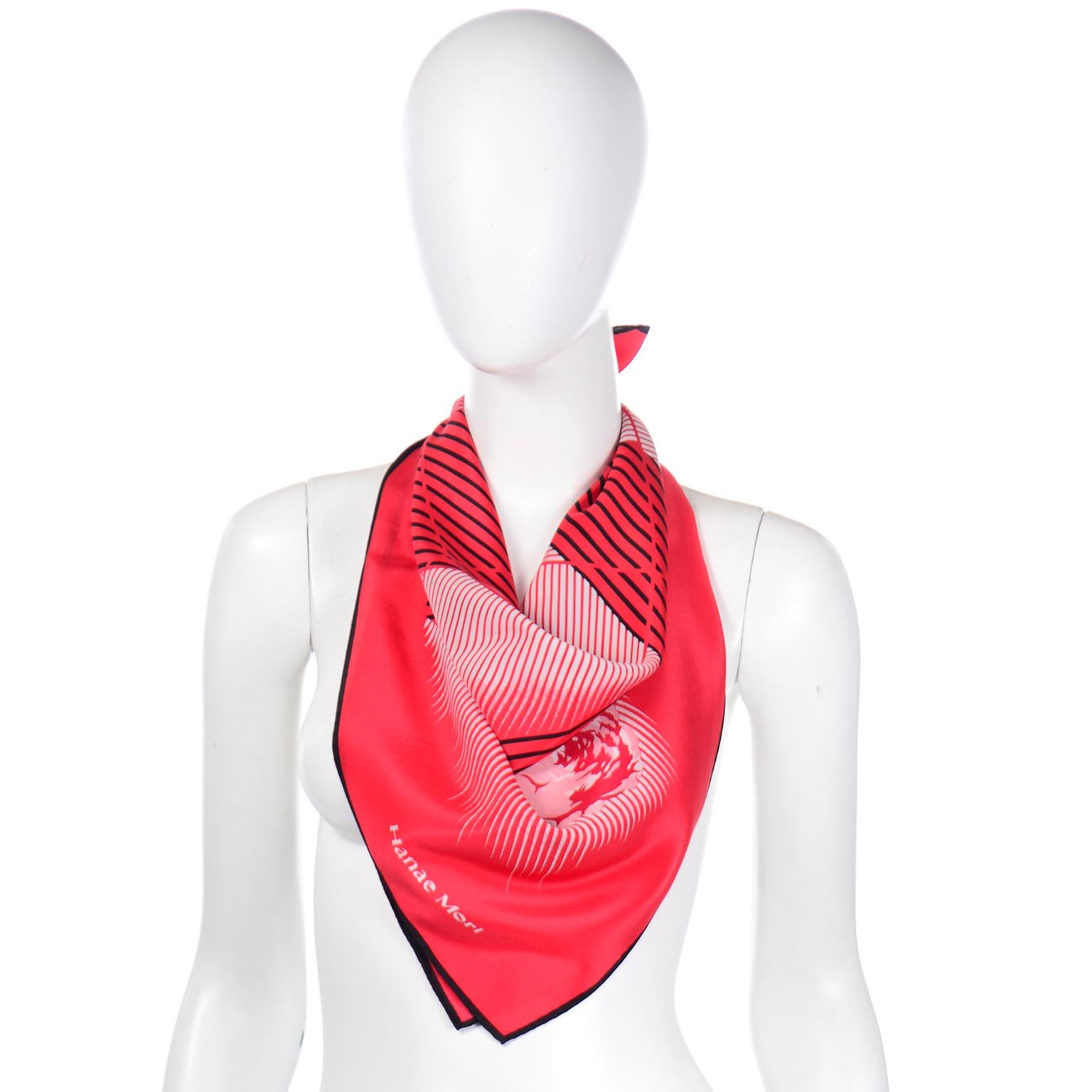 We absolutely love vintage Hanae Mori prints, and this beautiful red silk scarf is no exception! The pure silk scarf has stylized roses between white gradient lines and arches, with broken up black stripes. The shapes are a beautiful mix of