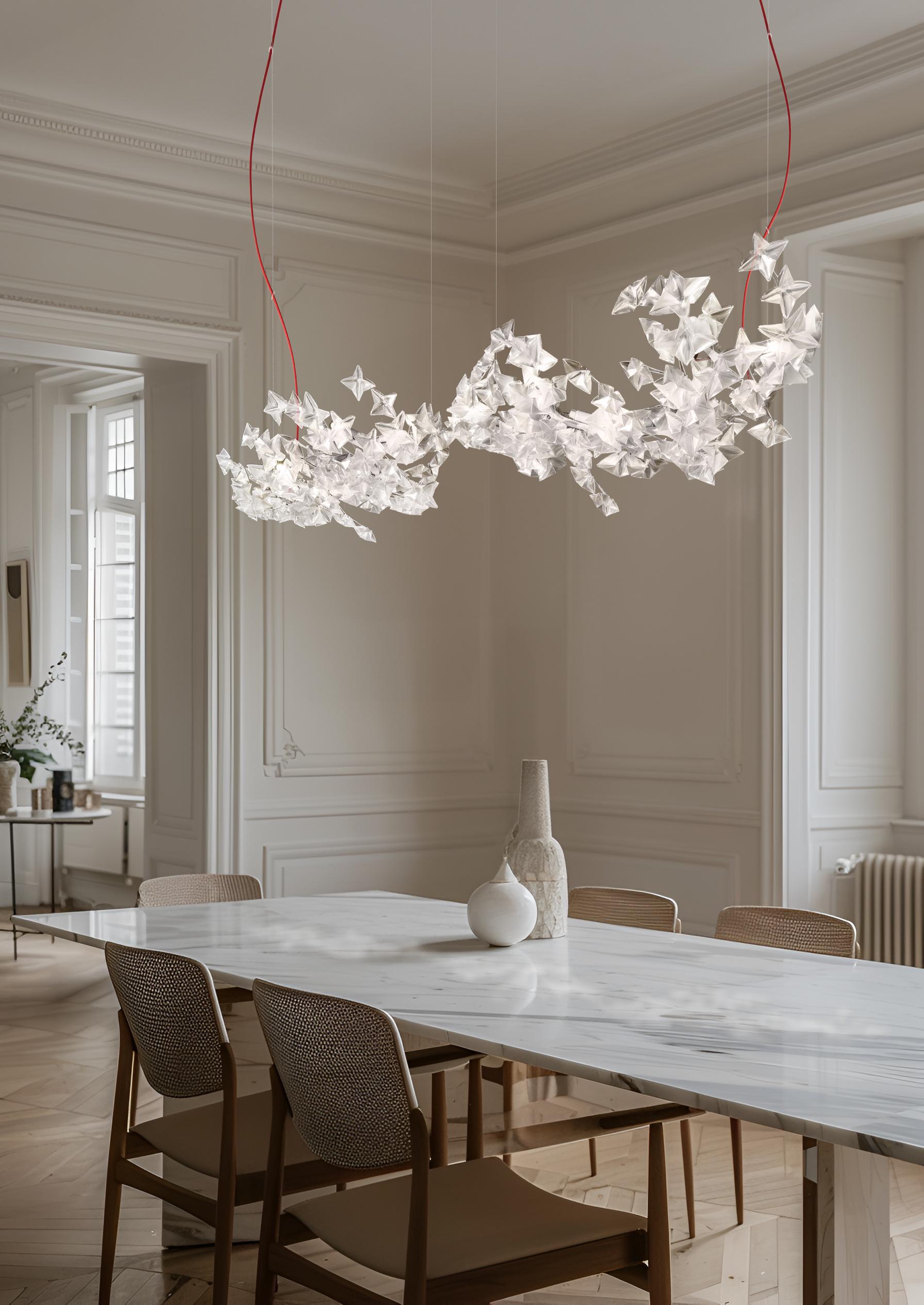 Hanami is a symbol of delicate poetry, taking its name from the traditional Japanese ritual of observing blossoming cherry trees. The Hanami family includes ethereal suspensions, available in two sizes, as well as an applique version that redefines