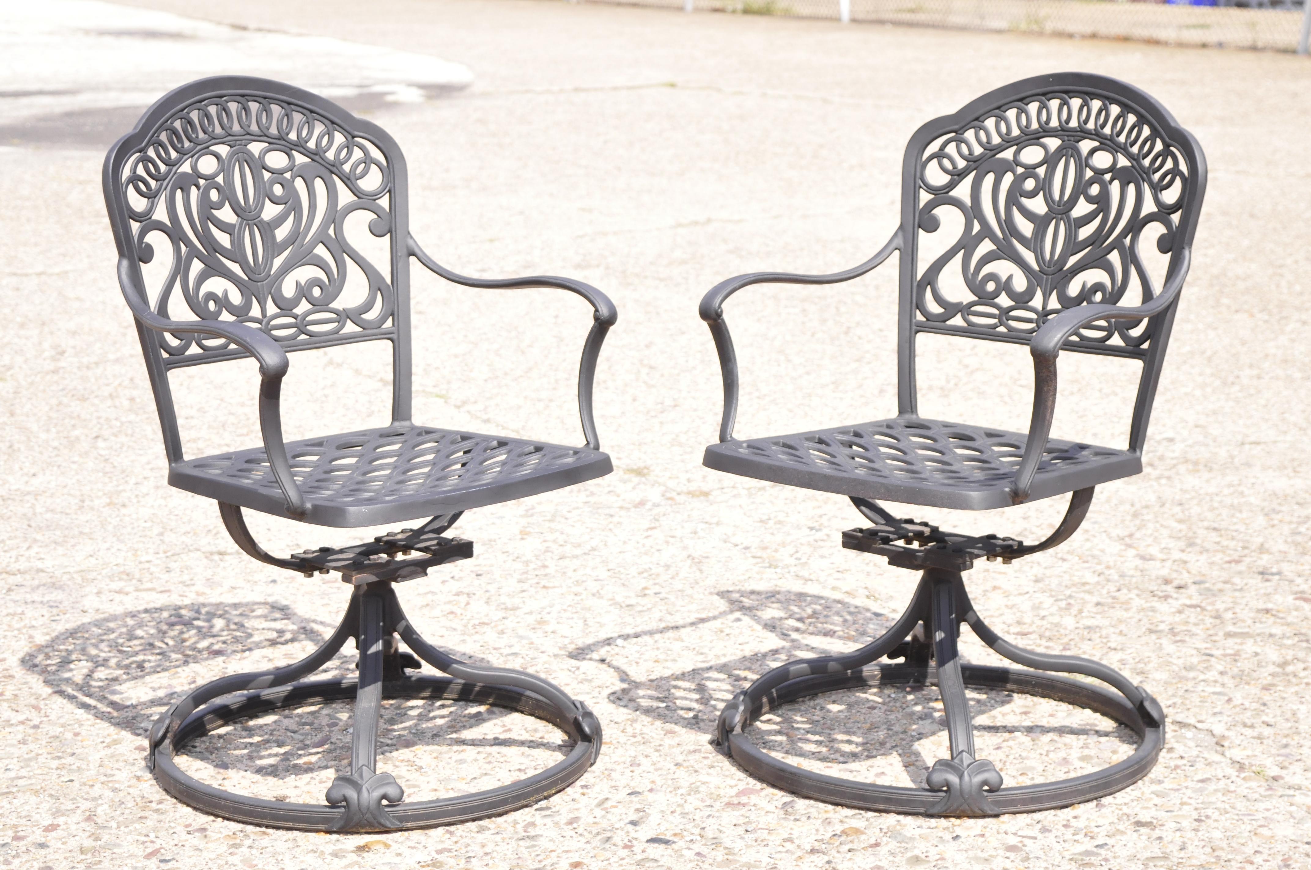 Hanamit Tuscan Swivel Rocker Cast Aluminum Patio dining chair - a pair. Item features swivel and tilt pedestal base, cast aluminum construction, very nice pair, great style and form. 21st Century, Pre-owned. Measurements: 35