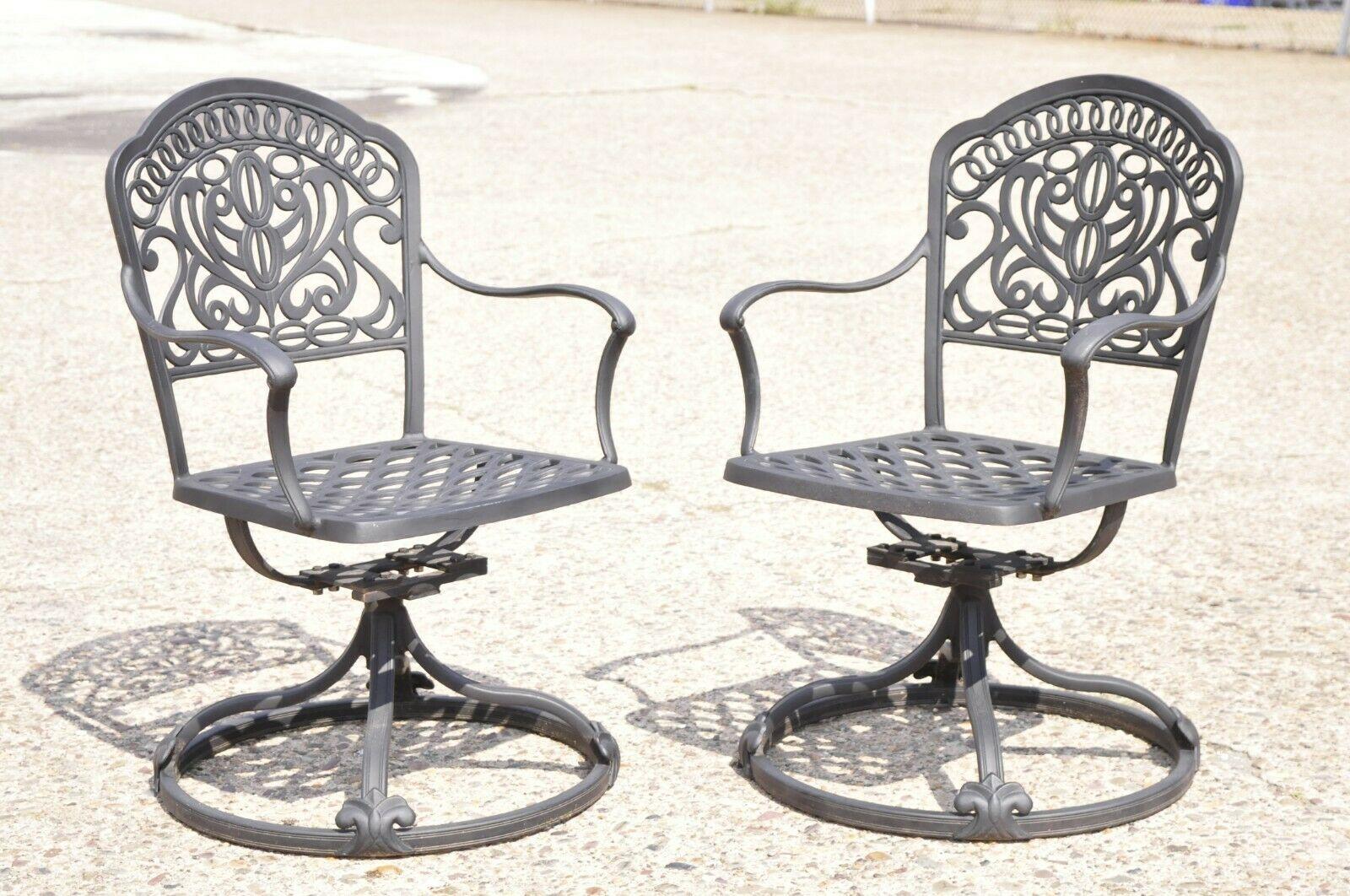 Hanamit Tuscan Swivel rocker cast aluminum patio dining chair - a pair. Item features a swivel and tilt pedestal base, cast aluminum construction, very nice pair, great style and form. Circa 21st century, Pre-owned. Measurements: 35