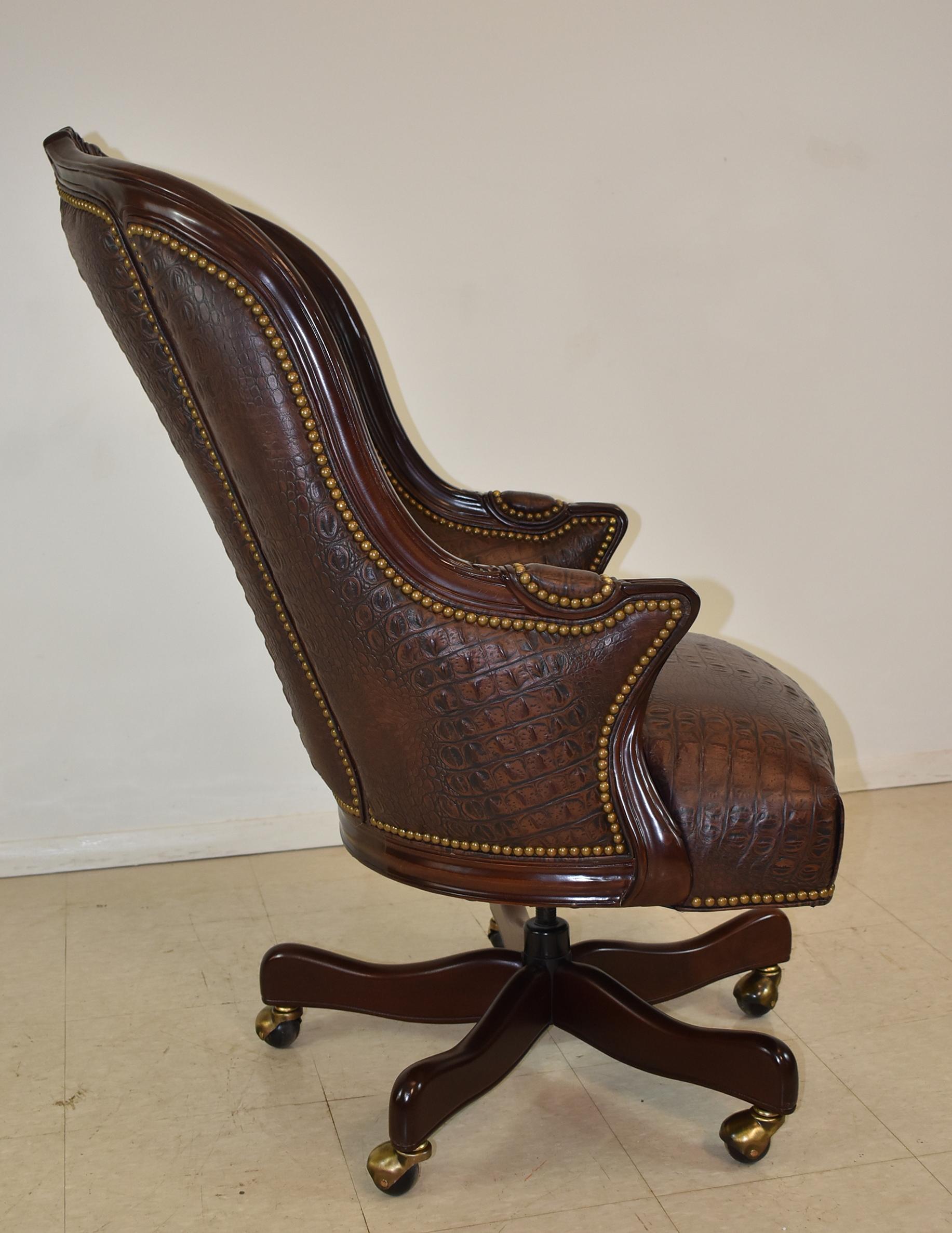 Hancock & Moore executive swivel office chair. Featuring genuine brown leather with a crocodile embossed design. Brass caster wheels. Nail head trim. Very nice to new condition. Dimensions: 33