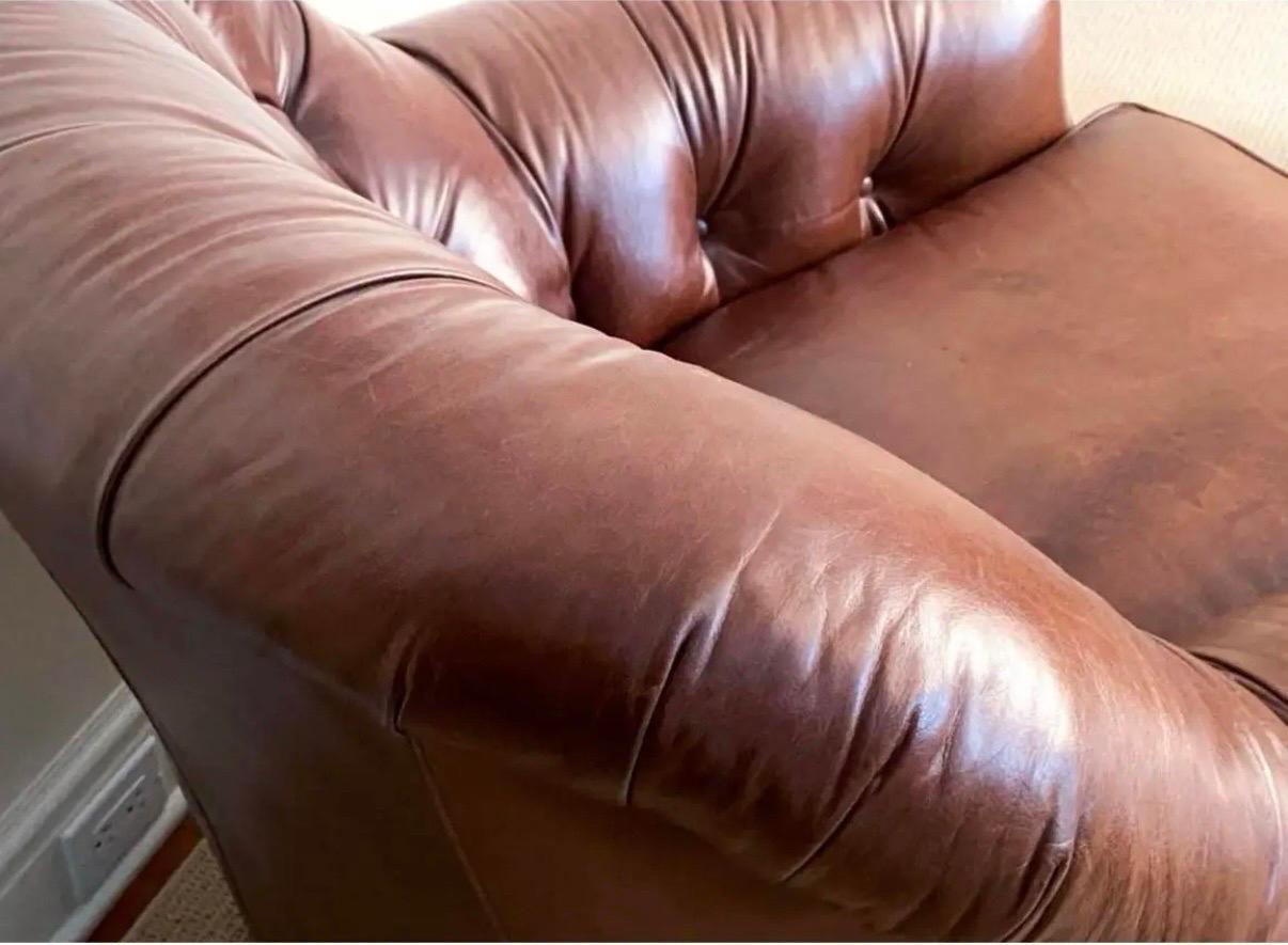 Handsome signed Hancock & Moore tufted brown leather chesterfield club chair and matching ottoman.  Brass tacks throughout and all vendor hallmarks are present.  Ottoman dimensions are 18