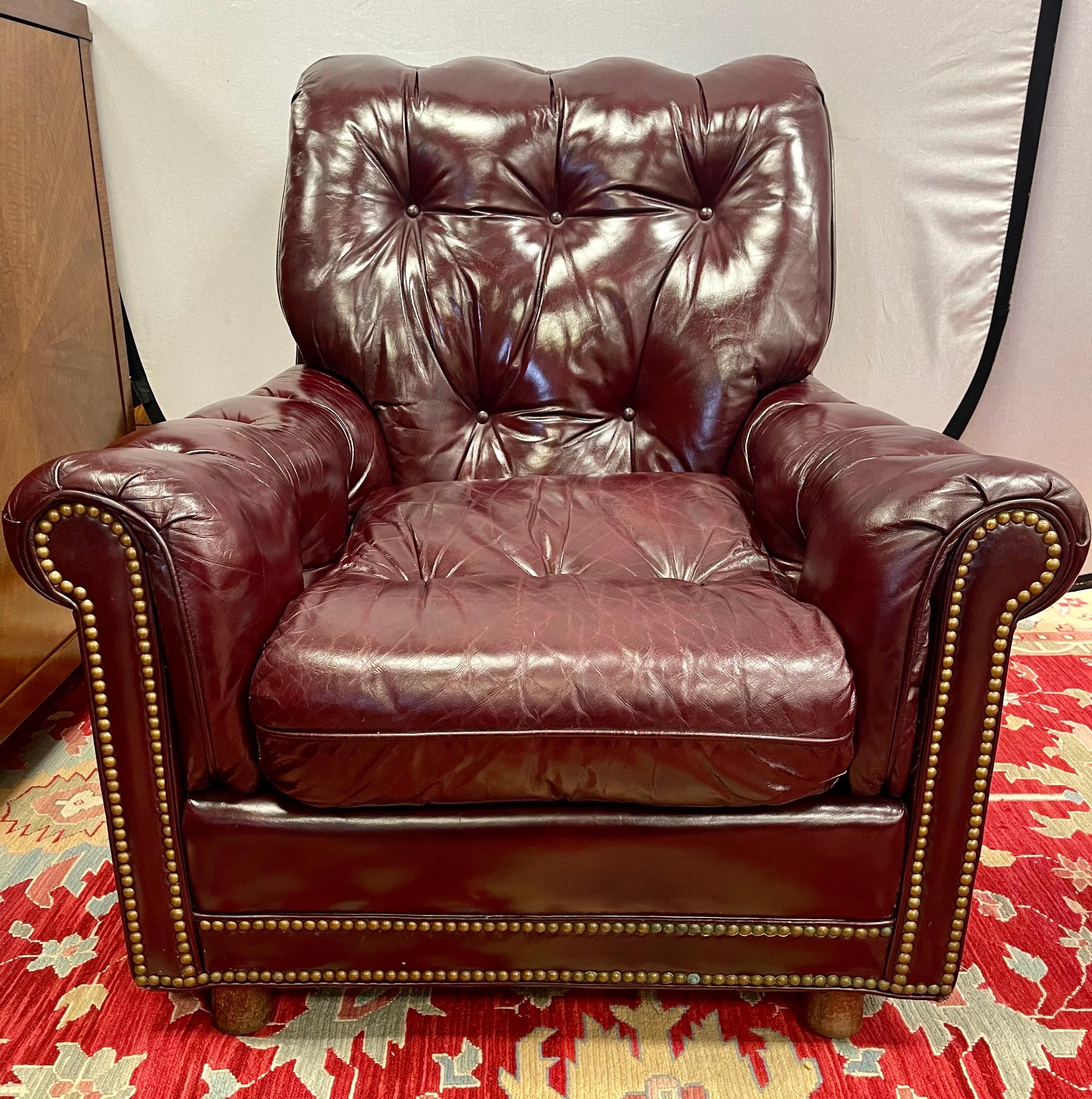 Vintage signed Hancock & Moore cranberry leather wing chair with nailheads throughout and a perfectly broken in patina to the leather. Will be one of your most comfortable chairs. Why not own the best.