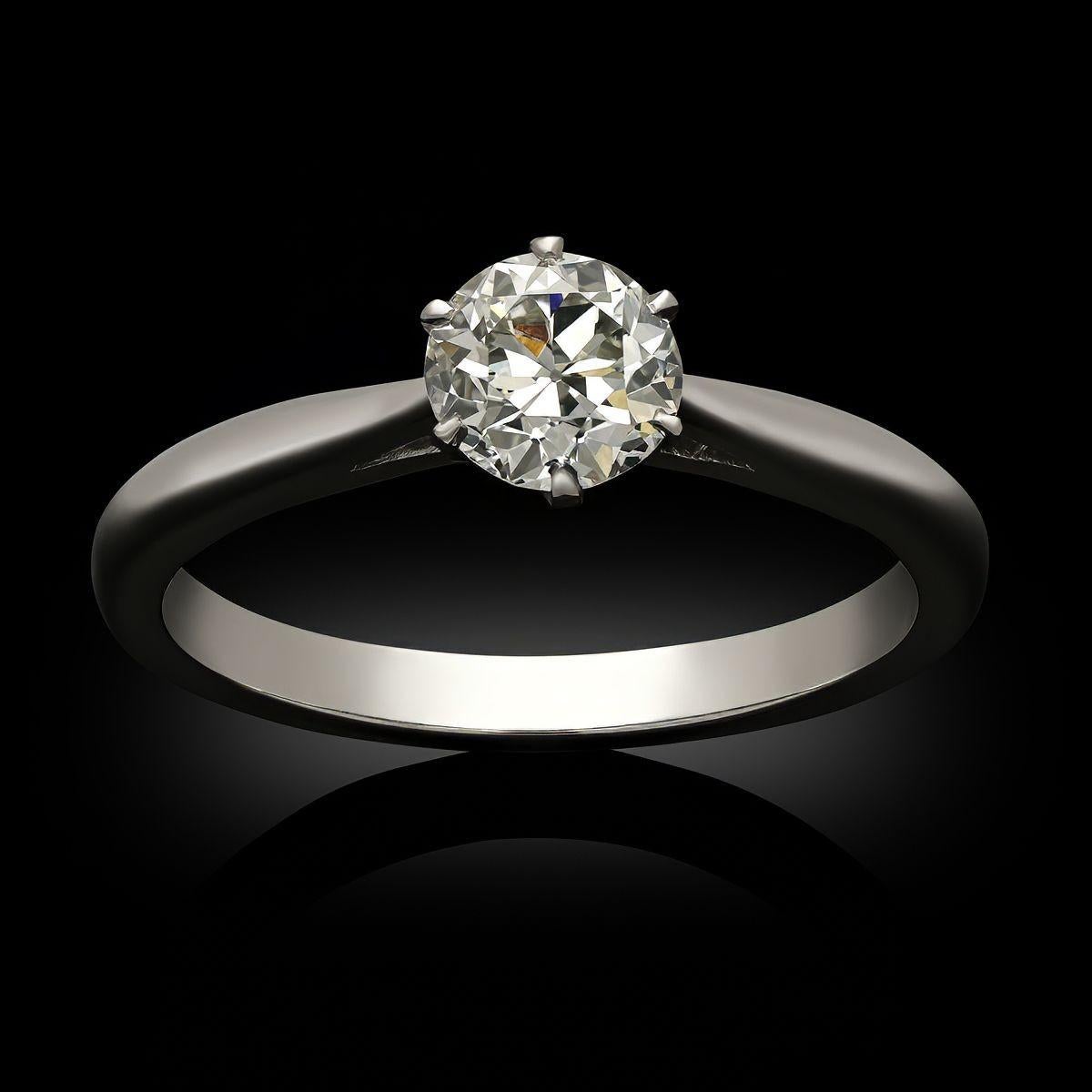 An old cut diamond and yellow gold solitaire ring by Hancocks. The ring is set with a 0.59ct old European cut diamond set with platinum claws and a scalloped gallery to a handcrafted platinum band with tapering shoulders and a polished D-shape