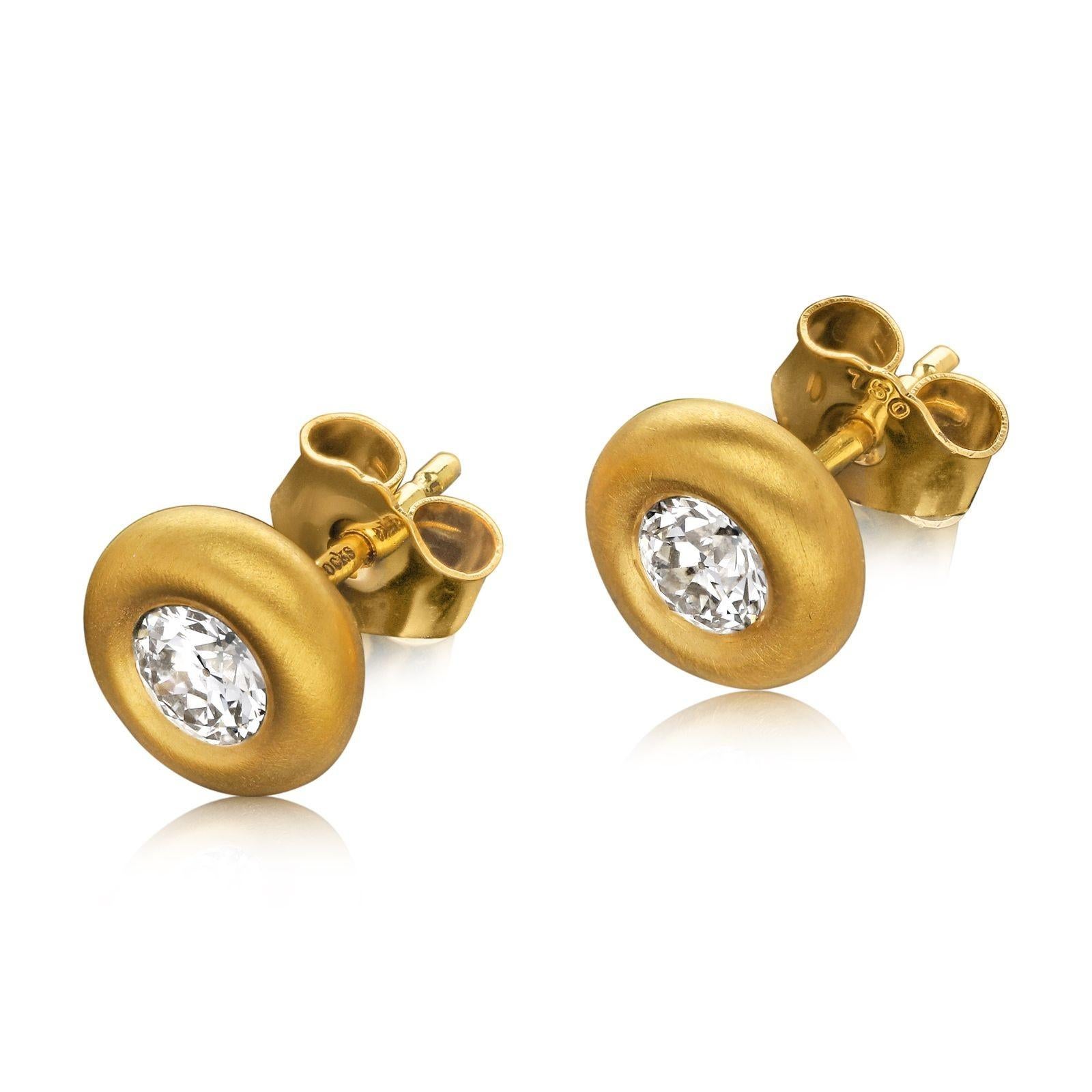 A beautiful pair of old cut diamond and yellow gold earrings by Hancocks, each earring set with an old European brilliant cut diamond weighing 0.30cts each and of H/I colour and VS clarity, bezel set within a rounded doughnut-style setting in satin