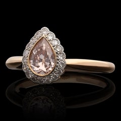 Hancocks 0,71ct Fancy Orangy Pink Colour Old Cut Pear Shape Diamond Halo Ring