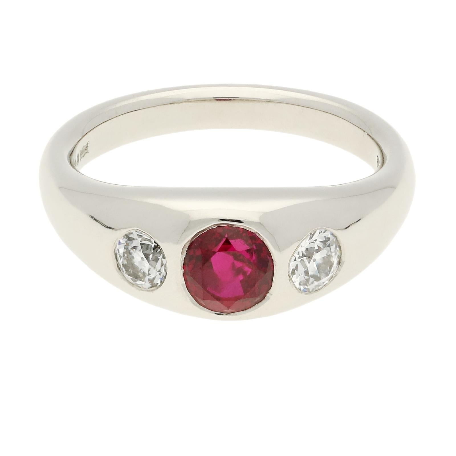 A beautiful platinum, ruby and diamond set ring by Hancocks, set flush to the centre with a lovely Burmese ruby weighing 1.09ct between two smaller old European brilliant cut diamonds weighing 0.40cts in total, within a hand crafted highly polished