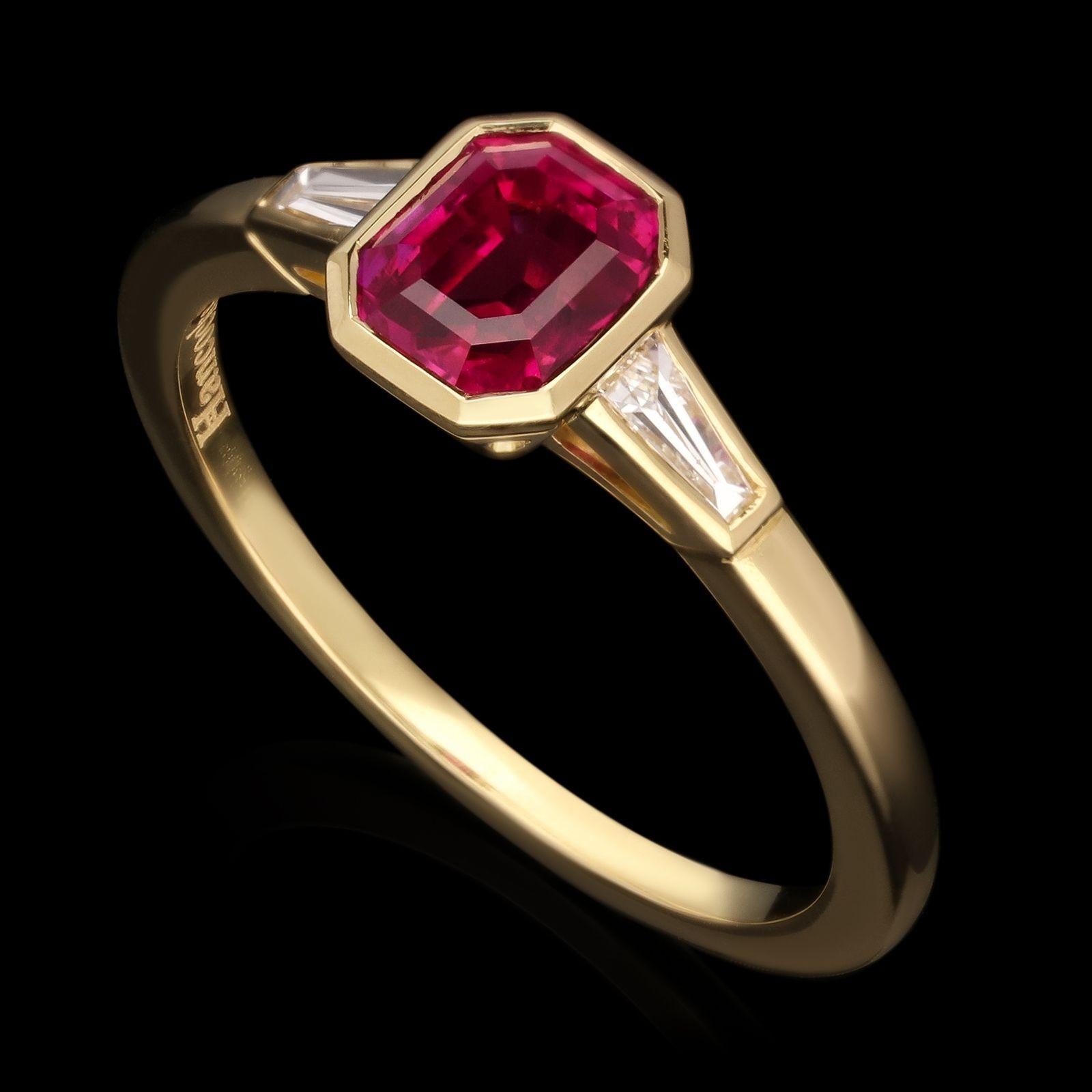 A beautiful ruby and diamond ring by Hancocks, centred on a lovely rich and deeply saturated emerald-cut ruby of Burmese origin weighing 1.09cts rub over set in 18ct gold between elegant tapering shoulders set with tapered baguette cut diamonds also