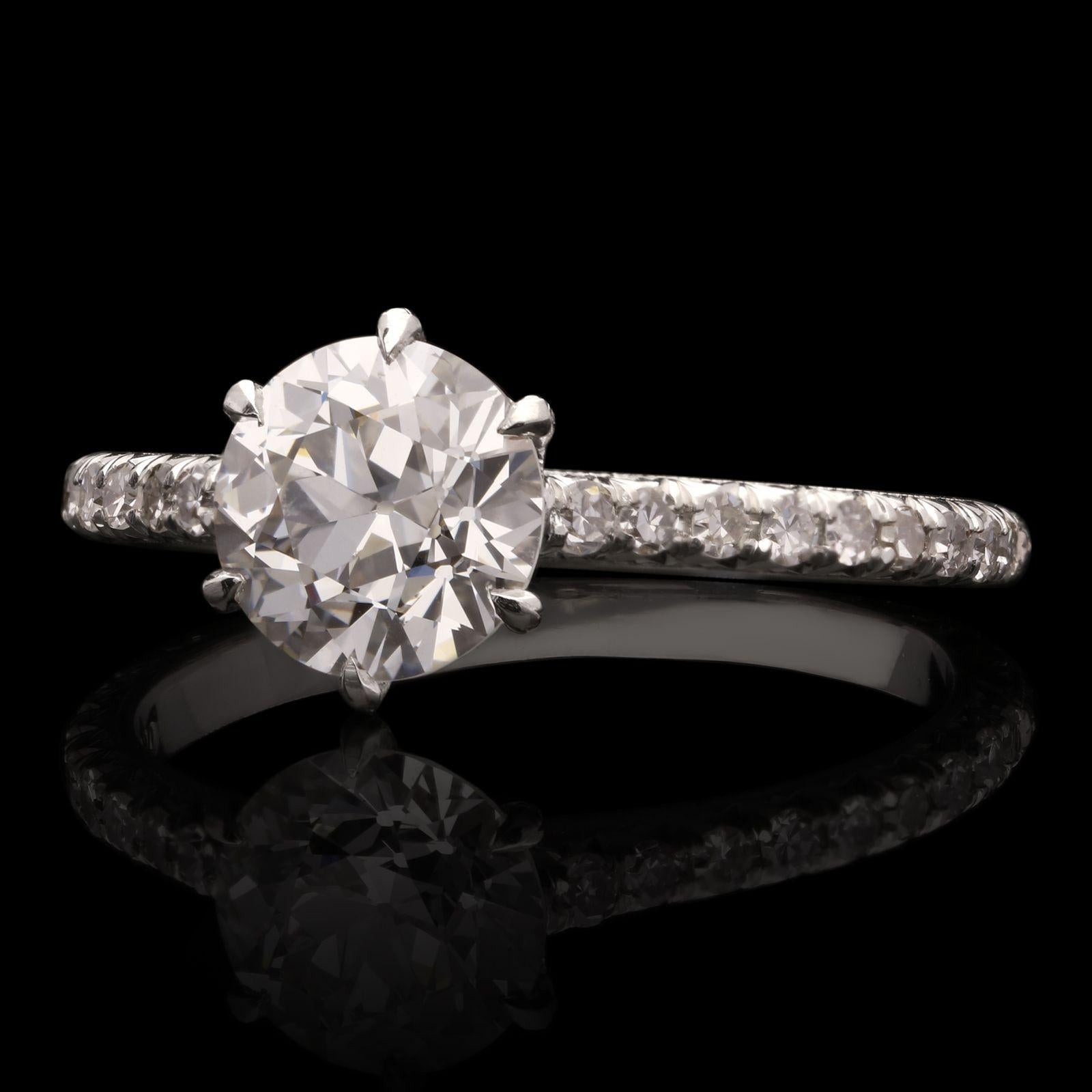 A classic diamond solitaire ring by Hancocks, centred on a beautiful old European brilliant cut diamond weighing 1.35cts and of F colour and VS2 clarity claw set in a handmade platinum mount with an open gallery embellished with diamonds and a fine