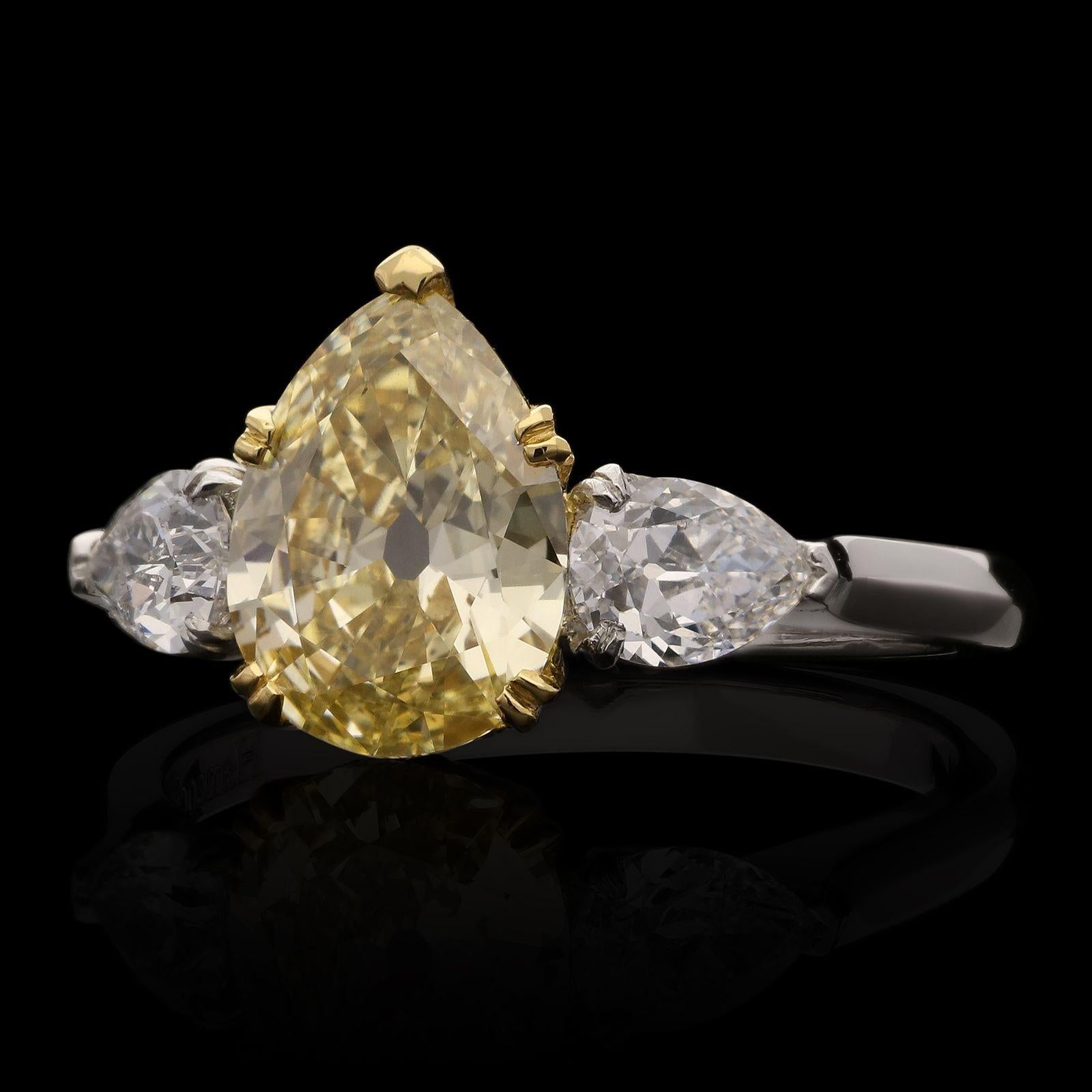 A beautiful fancy colour diamond ring by Hancocks, set with an old-cut pear-shaped diamond weighing 1.49ct and of Fancy Yellow colour and VS2 clarity, in an 18ct yellow gold double claw setting between shoulders of pear shaped diamonds set
