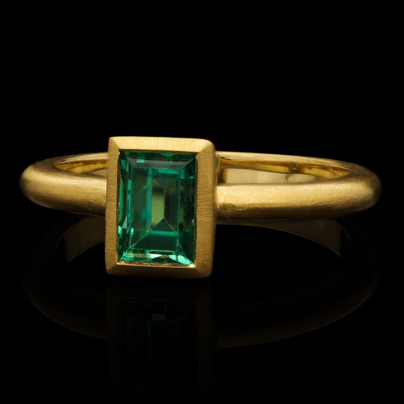 A striking emerald and yellow gold ring by Hancocks, centred with an old rectangular step cut Russian emerald weighing 1.56ct and with no oil treatment, bezel set within a finely hand crafted 22ct yellow gold mount with knife edge band and softly