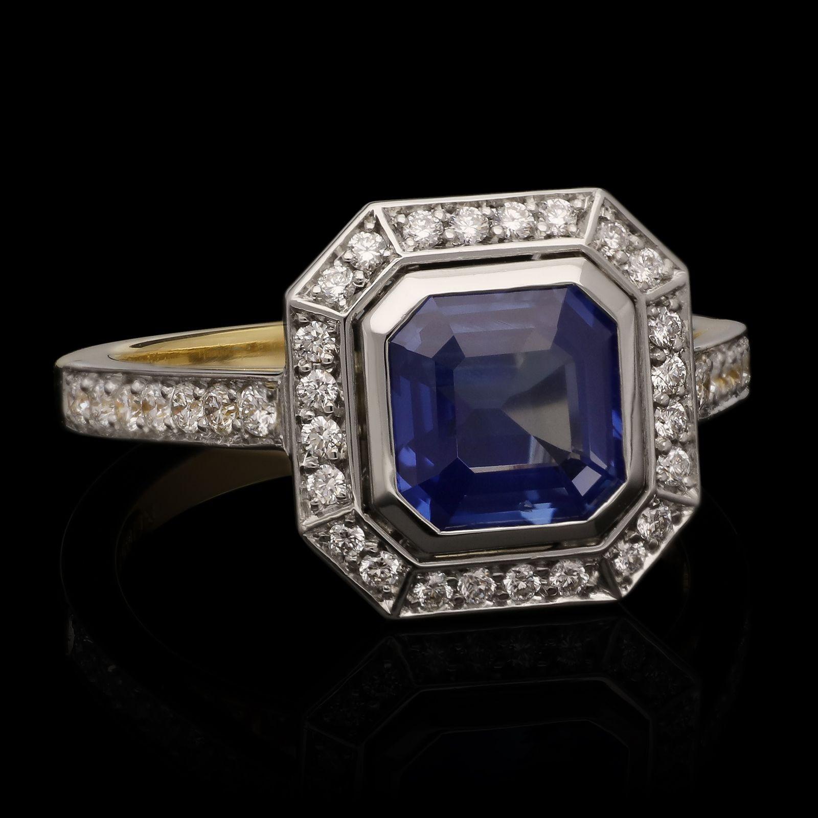 A beautiful geometric sapphire and diamond halo ring by Hancocks, centred with an octagonal step cut unheated sapphire weighing 1.59ct in a platinum rubover setting surrounded by a detached halo of round brilliant cut diamonds all in a hand crafted
