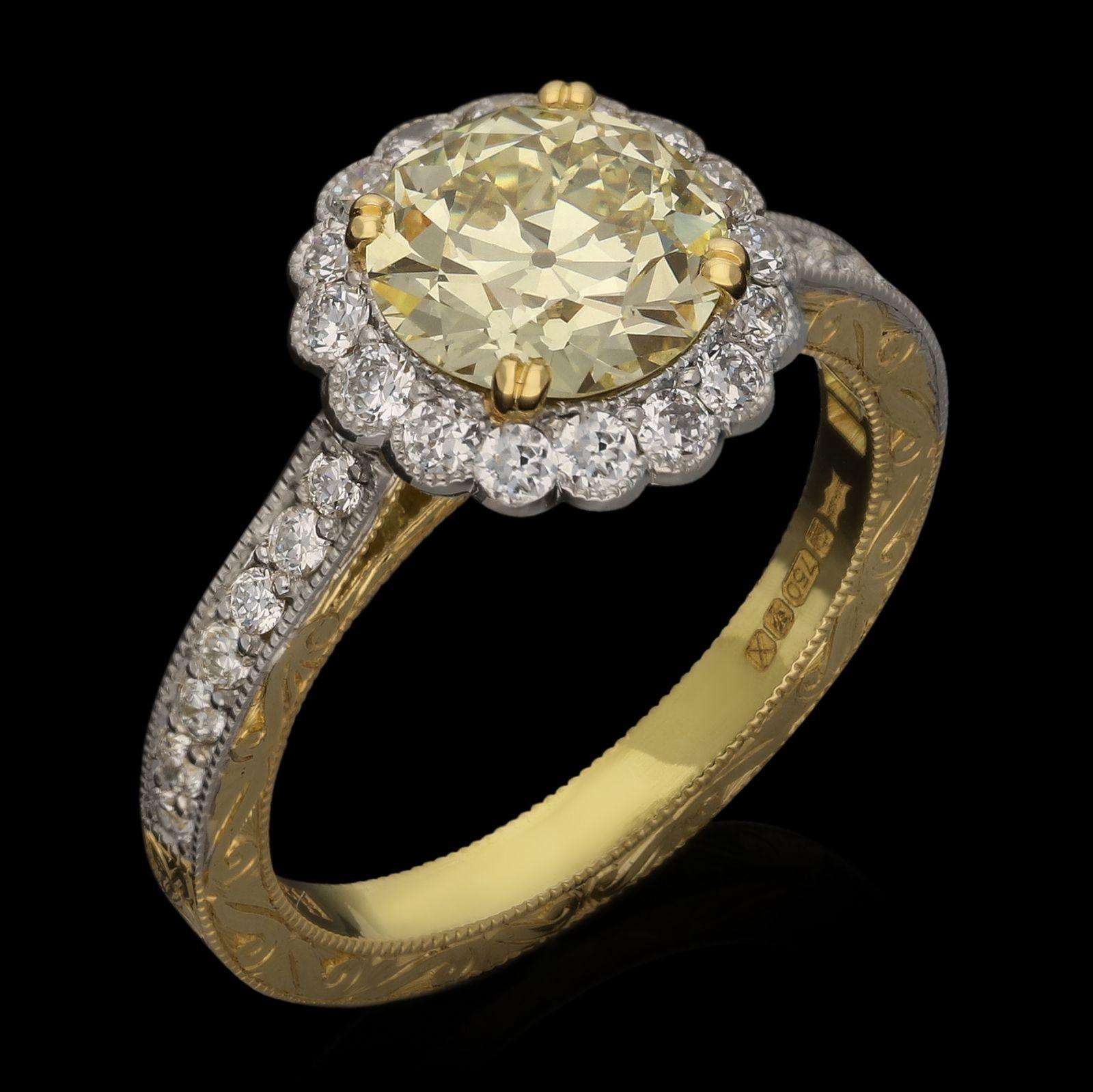 A beautiful old cut diamond cluster ring by Hancocks, centred with a bright and lively pale yellow old European brilliant cut diamond weighing 1.62ct and of U-V colour and SI1 clarity, claw set in 18ct gold and surrounded by a fine frame of old