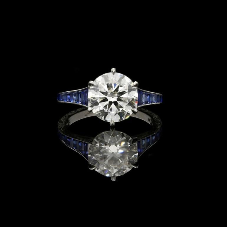 Please note this ring is made to order 8 weeks - design as per photographs.
2.04ct Carat H VS1 old European brilliant cut diamond with GIA certificate 
Calibre cut sapphires weighing a total of 0.50 Carats
Platinum with maker's signature
4.0