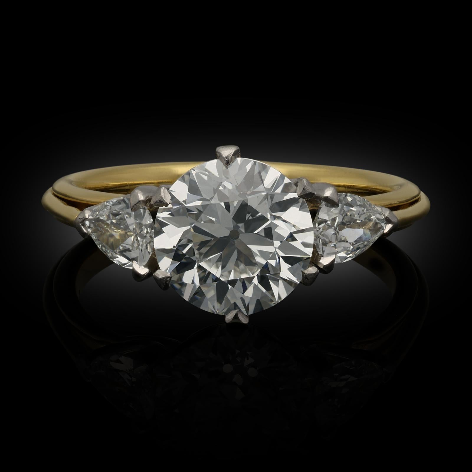A beautiful old European brilliant cut diamond weighing 2.14cts claw set in 18ct yellow gold and platinum with open scooped gallery between shoulders set with old cut pear shaped diamonds in platinum claw settings, all to a finely hand crafted gold