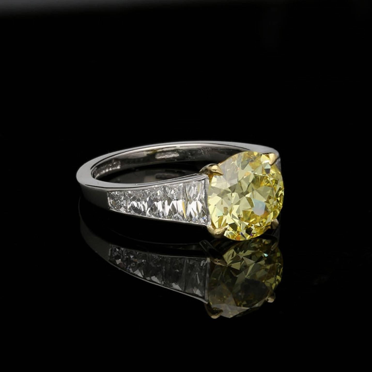 2.41 carat Natural Fancy Intense Yellow VS1 old European cut diamond with GIA certificate 
1.01 carats total of D VS tapering French cut diamonds
0.08 carats of single cut yellow diamonds
Platinum and 18ct yellow gold with maker's signature and