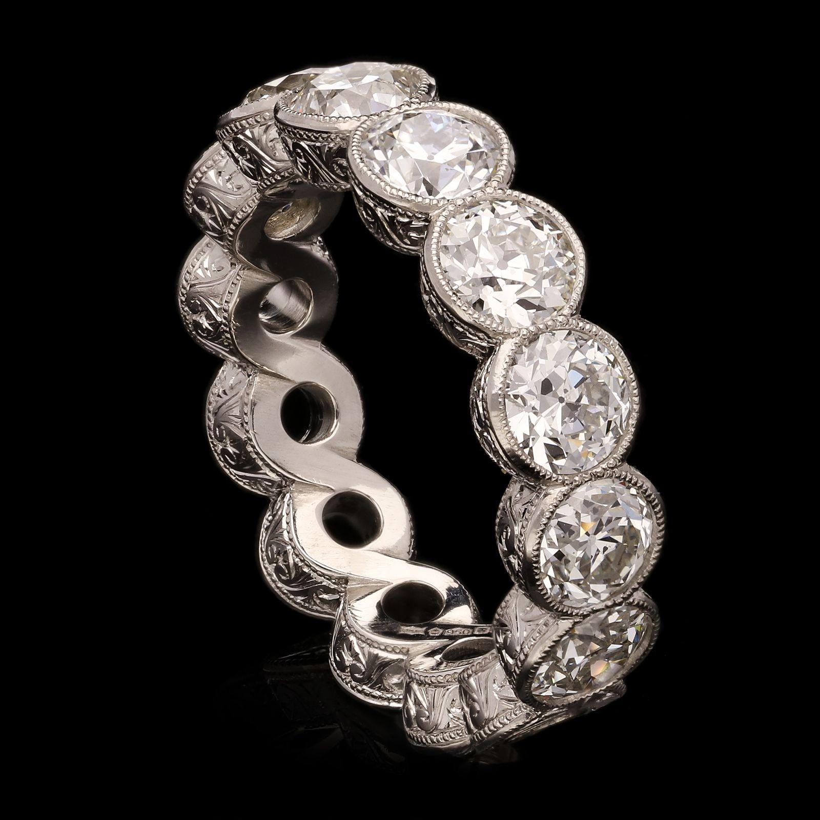 A beautiful diamond half eternity ring set with old European brilliant cut diamonds weighing a total of 2.80cts all rub over set in a finely crafted figure-of-eight style platinum mount with millegrain edging and beautifully ornate hand engraved