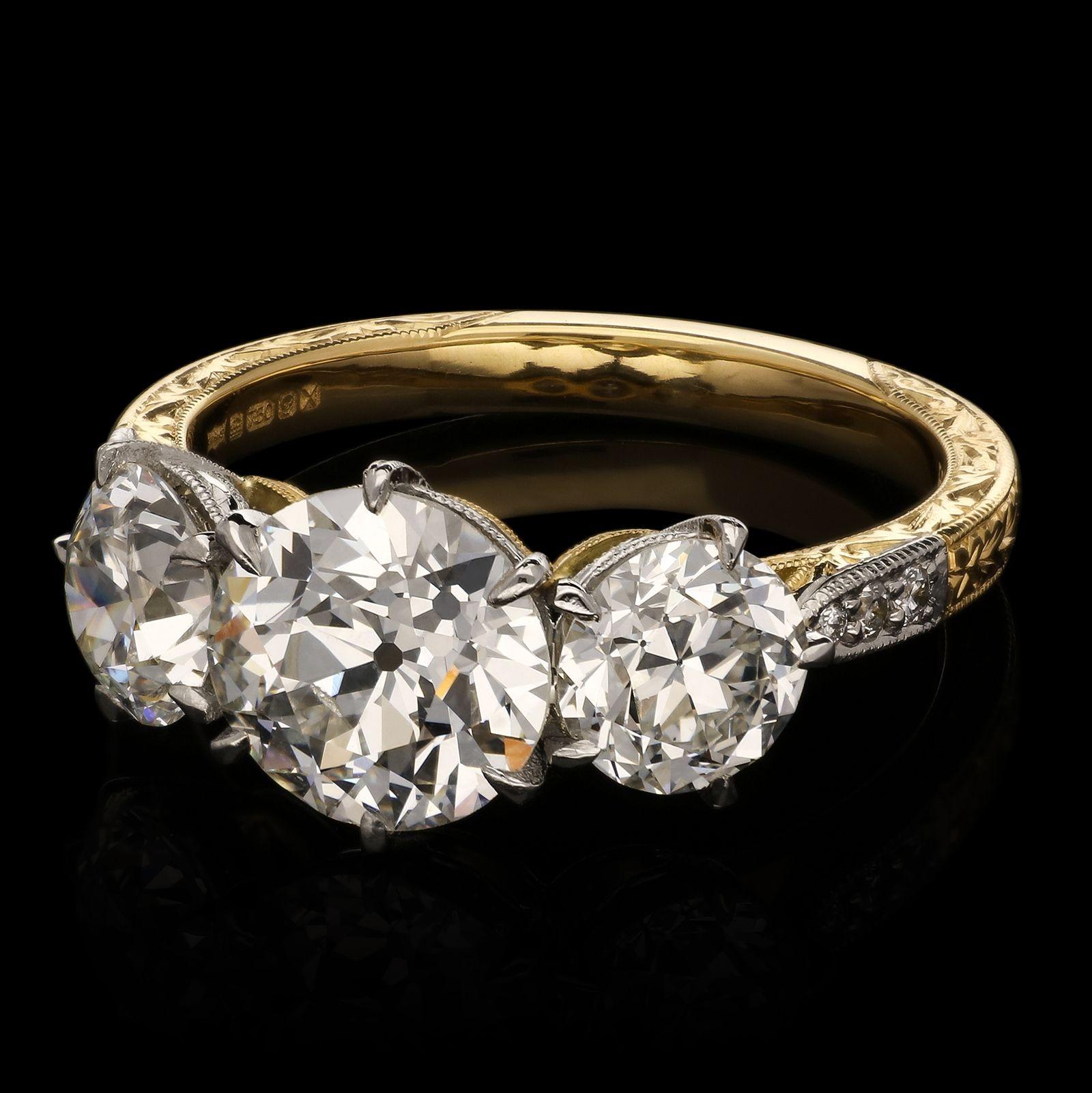A beautiful old-cut diamond and 18ct gold three stone ring by Hancocks, set to the centre with an old European brilliant cut diamond weighing 1.63cts and of F colour and VS1 clarity claw set in platinum between two further old European brilliant