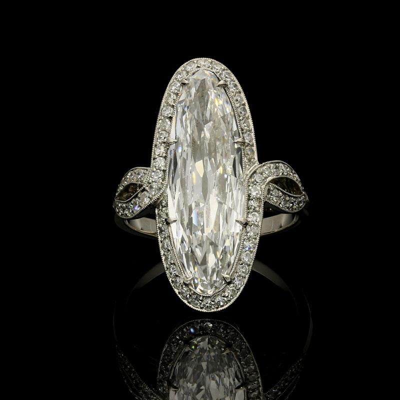 3.64 Carat D IF marquise brilliant cut diamond with GIA certificate.
Accompanied by an additional letter stating that the diamond is a Type IIA.
0.50 carats of round single cut diamonds
Platinum with maker's marks and London assay marks
UK finger