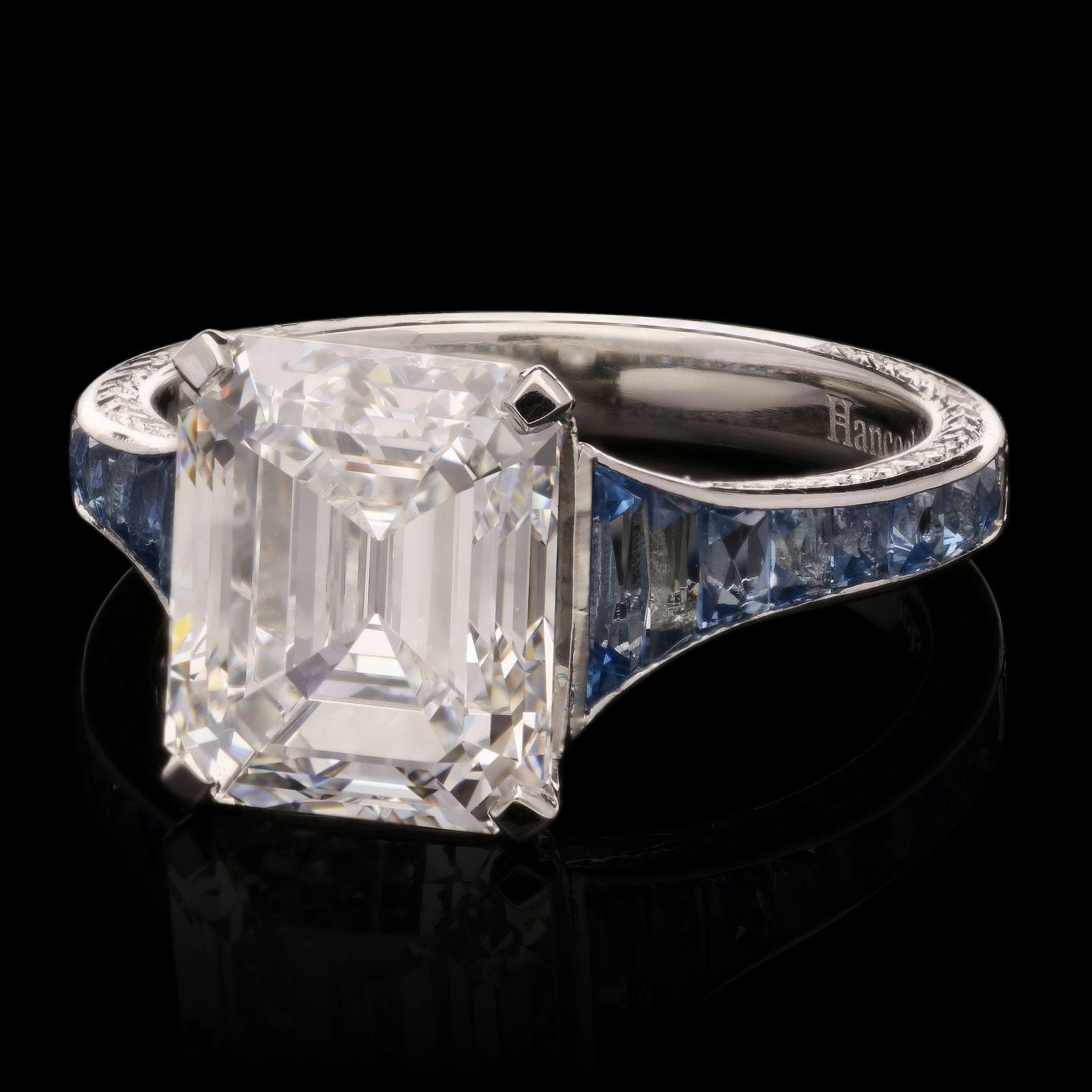 A beautiful old cut diamond and aquamarine ring by Hancocks, centred with a wonderful emerald-cut diamond weighing 4.48ct and of D colour and VS2 clarity in claw setting between shoulders channel set with calibre French-cut aquamarines, all in a