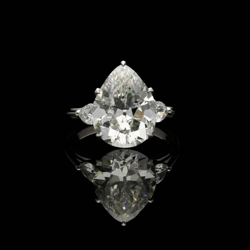 A stunning pear-shaped diamond ring by Hancocks, centred on a beautiful old-cut pear-shape diamond weighing 4.48 Carats and of J colour and VVS1 clarity claw set to a simple, elegant scalloped gallery between delicate pear-shape diamond shoulders,