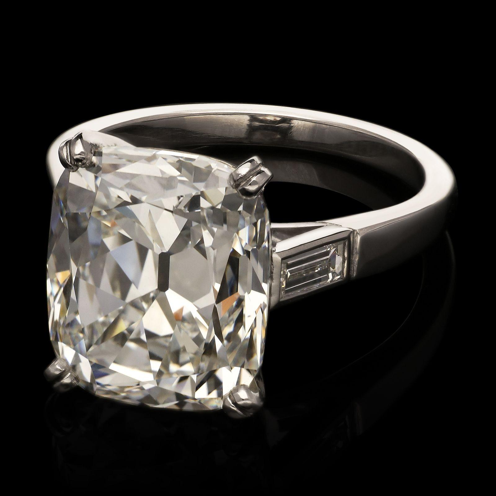 A stunning old cut diamond and platinum ring by Hancocks, set with a beautiful old mine brilliant cut diamond weighing 8.88ct and of G colour and VS2 clarity, corner claw set to a simple double bar gallery, between elegant shoulders, each set with a