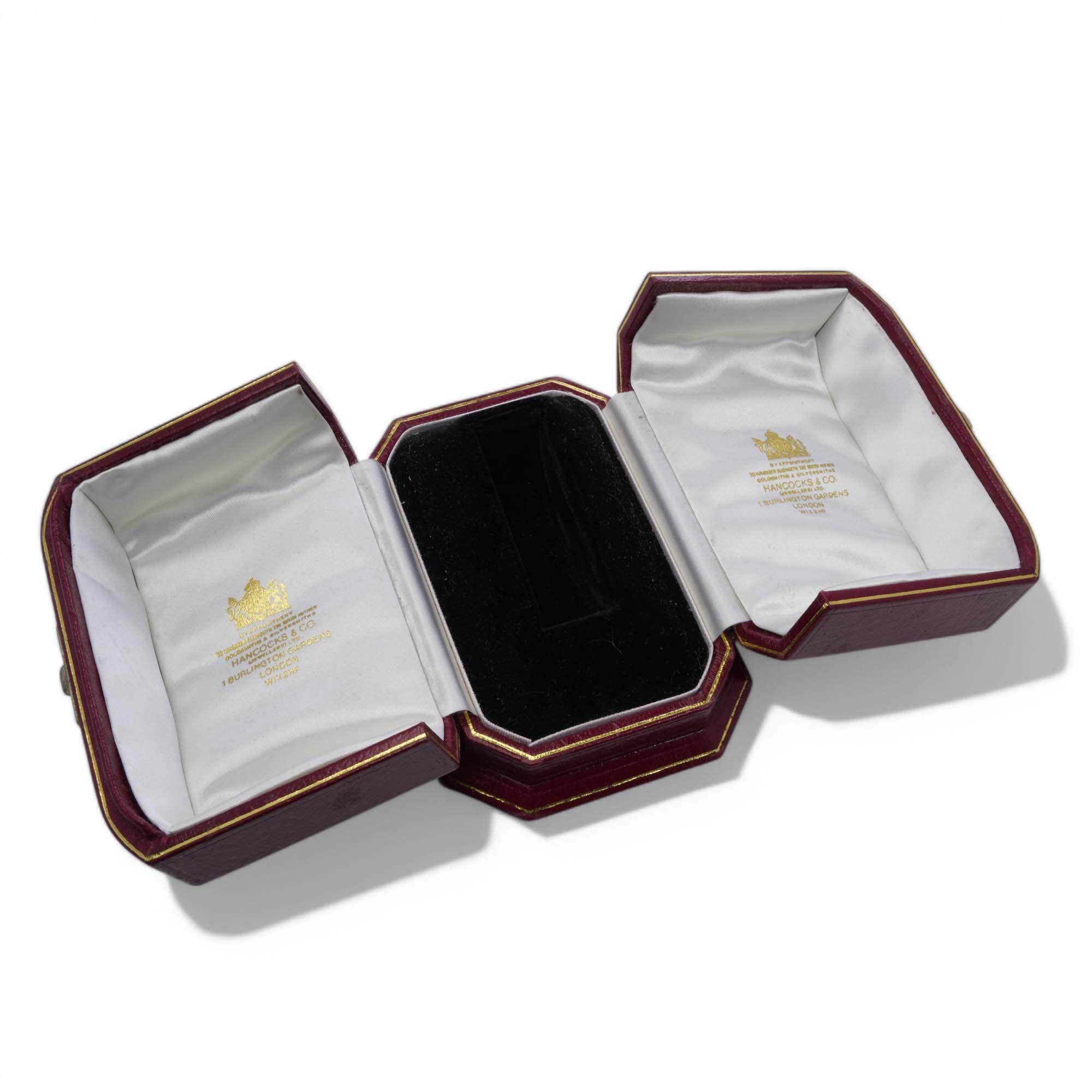 Hancocks & Co. Watch Box

Period: Early to mid 20th century
Material: Classic maroon leather case with gold trim and silk-lined interior
Purpose: Designed to hold and present a watch
Dimensions: Height: 10 cm, Width: 9 cm
Condition: Good; slight