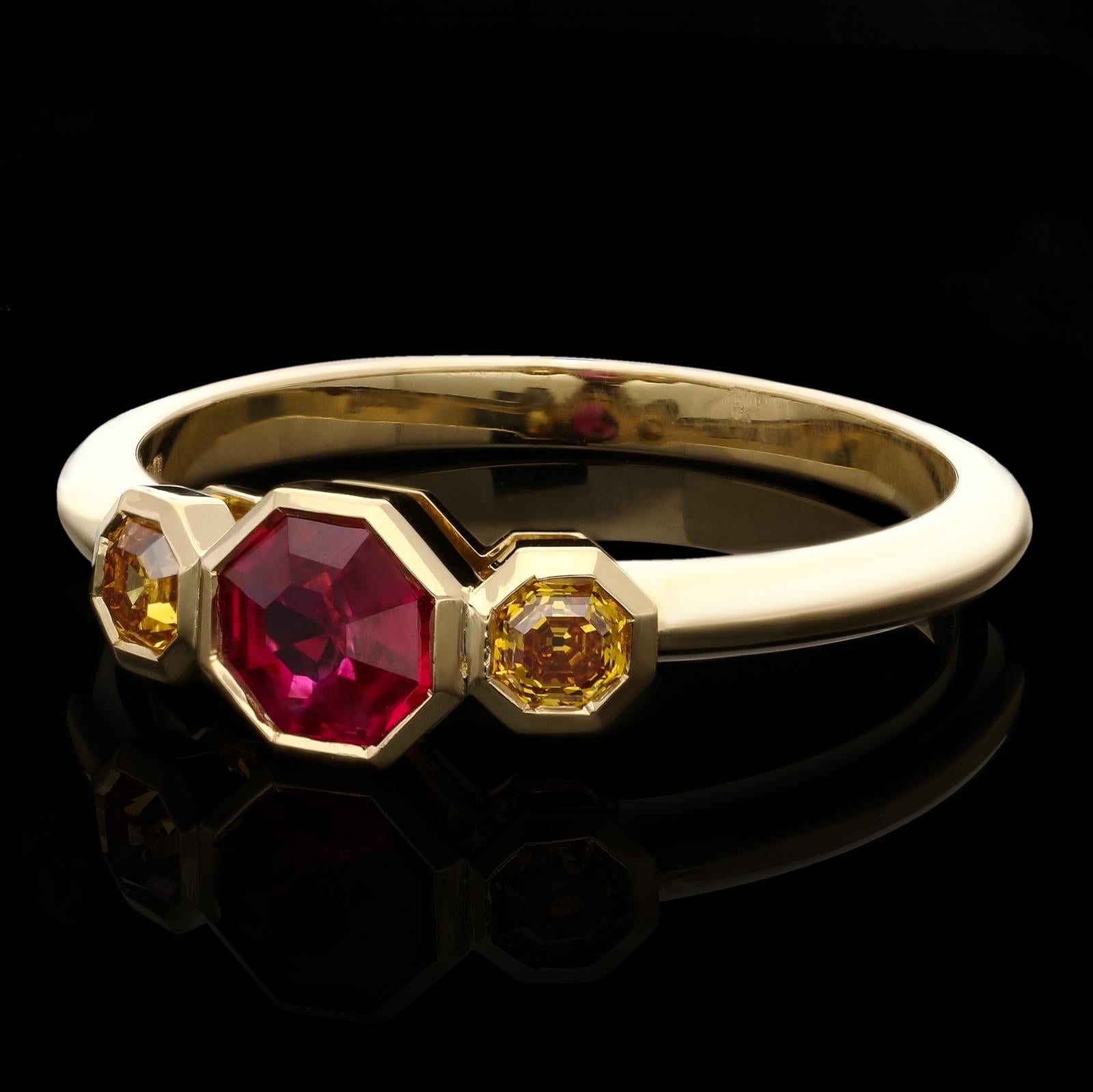 A beautiful and unusual ruby and fancy colour diamond three stone ring by Hancocks, centred with a richly coloured Assher cut Burmese ruby weighing 0.52cts between shoulders of octagonal fancy coloured orangey-yellow diamonds weighing 0.20ct in